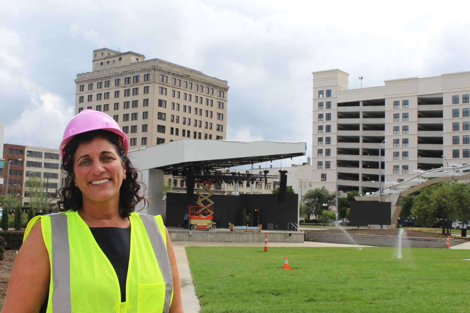 Lisa Wagner, executive director of the Levitt Pavilion Dayton, stands on the lawn in front of the new state-of-the-art music amphitheater. The shows begin next week.