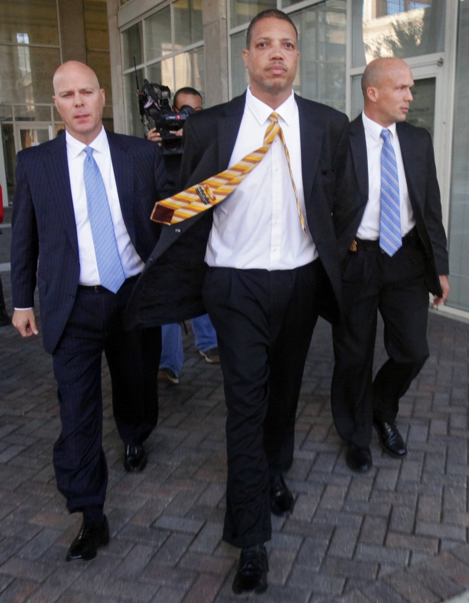 FBI agents escort Clayton Luckie to jail in 2012.