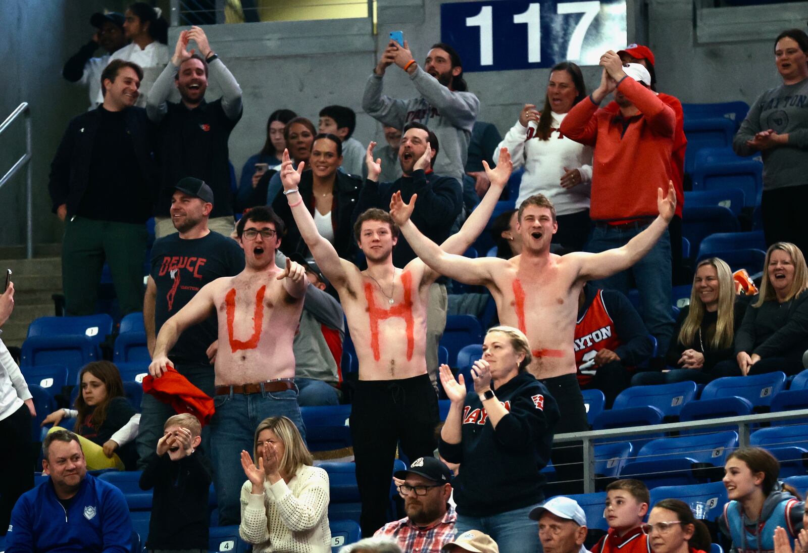 Friends of Dayton's Brady Uhl show off their painted chests during a game against Saint Louis on Tuesday, March 5, 2024, at Chaifetz Arena in St. Louis, Mo. David Jablonski/Staff