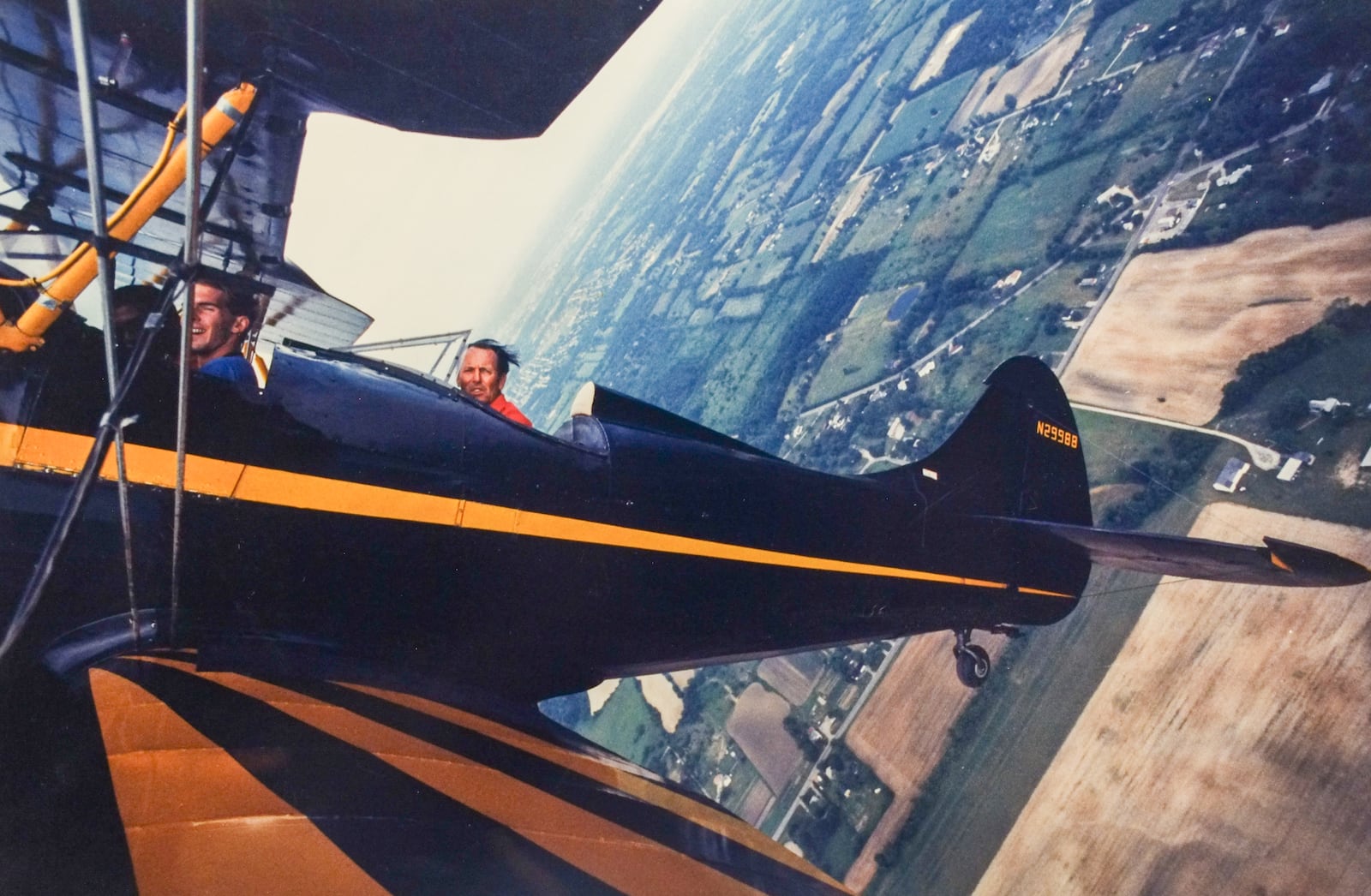 Harold Johnson - the flying Mayor of Moraine pull his WACO up into a loop over the farm fields of Montgomery County. Air show 1989. TY GREENLEES COURTESY OF WRIGHT STATE UNIVERSITY, DAYTON DAILY NEWS ARCHIVE