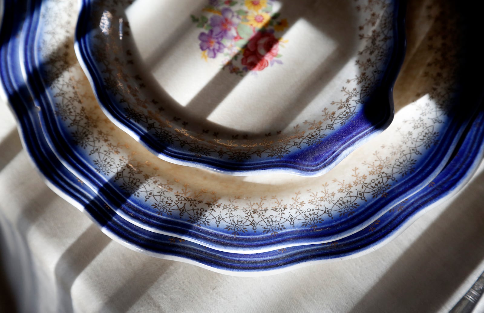 The place settings used by Paul Laurence Dunbar and his mother Matilda, dress the dining room table at the Paul Laurence Dunbar House. LISA POWELL / STAFF