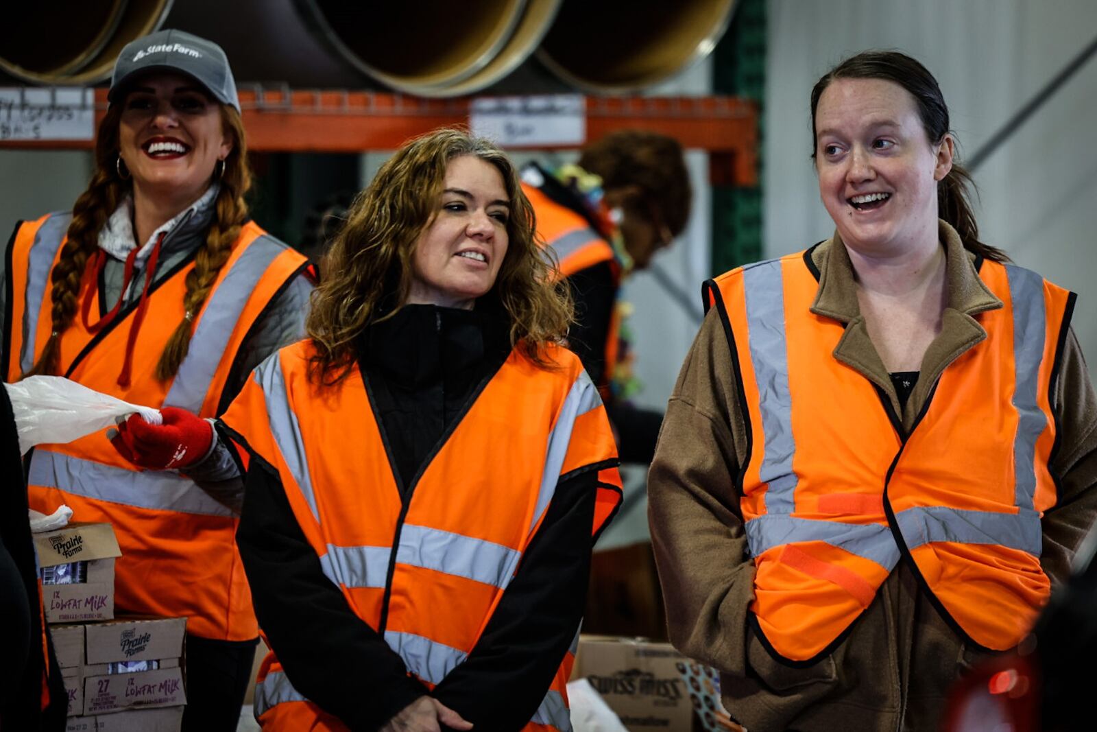 Dayton Daily News reporter, Aimee Hancock, right, helps other volunteers load food into vehicles Thursday morning November 17, 2022 at the Dayton Foodbank. JIM NOELKER/STAFF