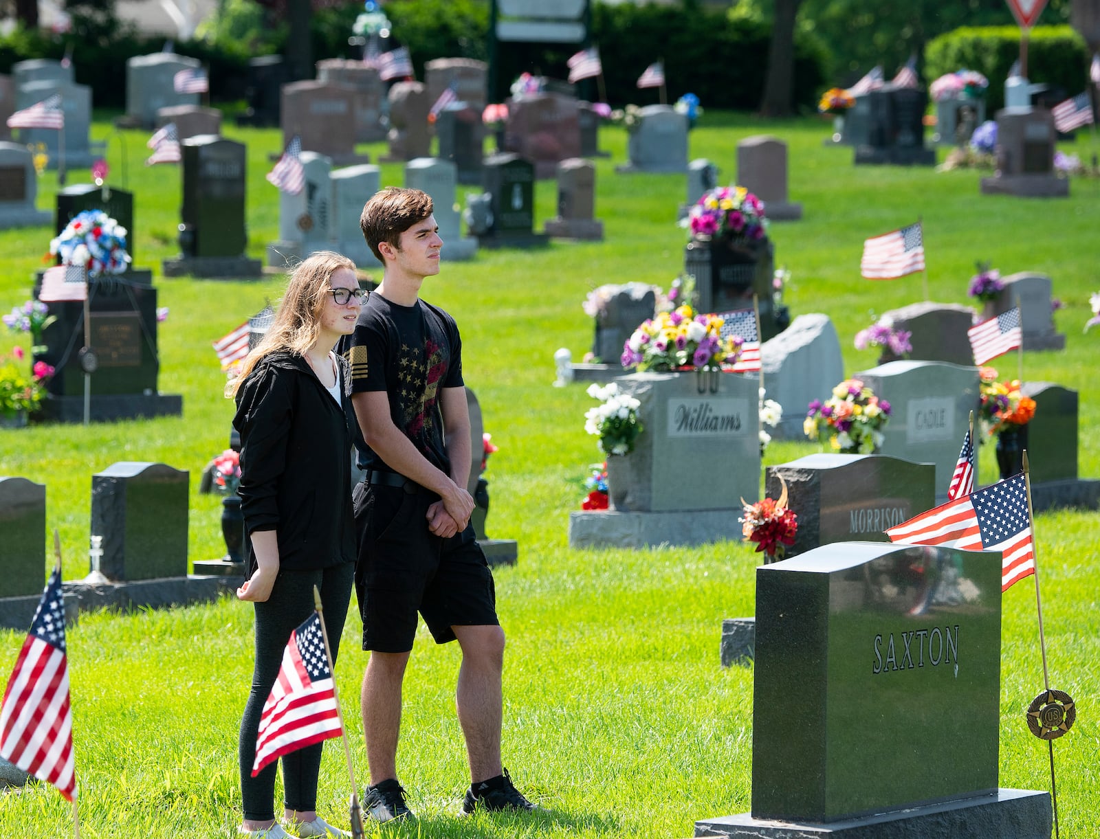 Karen Jenkins and Kenneth Alvarez stand amongst the headstones in Fairfield Cemetery May 30, watching the Memorial Day ceremony in Fairborn. Veteran organizations and Boy Scouts decorated the graves of veterans with American flags. U.S. Air Force photo/R.J. Oriez