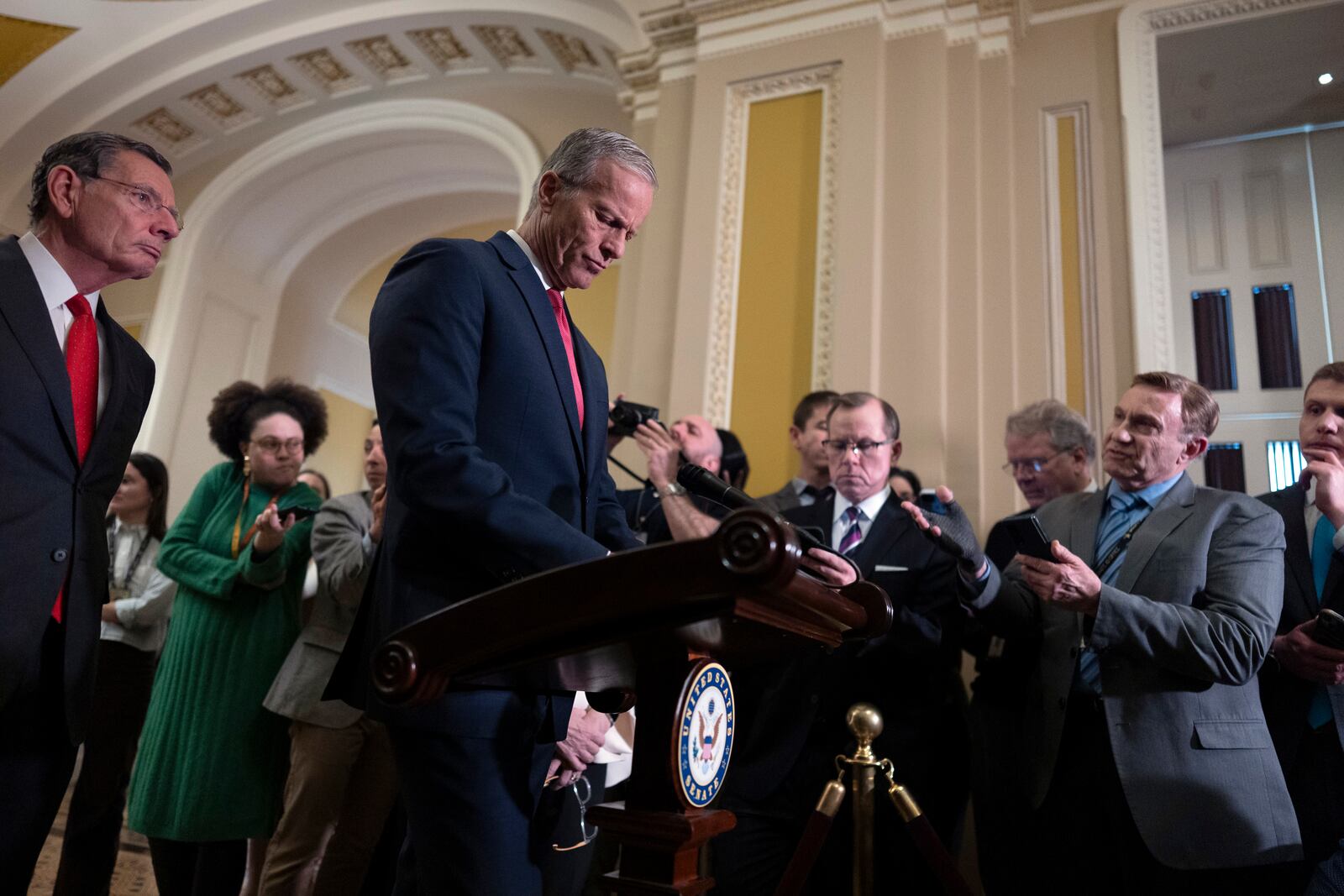 Senate Majority Leader John Thune, R-S.D., joined at left by Sen. John Barrasso, R-Wyo., the GOP whip, speaks to reporters after meeting with Vice President JD Vance and fellow Republicans to discuss President Donald Trump's agenda, at the Capitol in Washington, Wednesday, Feb. 19, 2025. (AP Photo/J. Scott Applewhite)