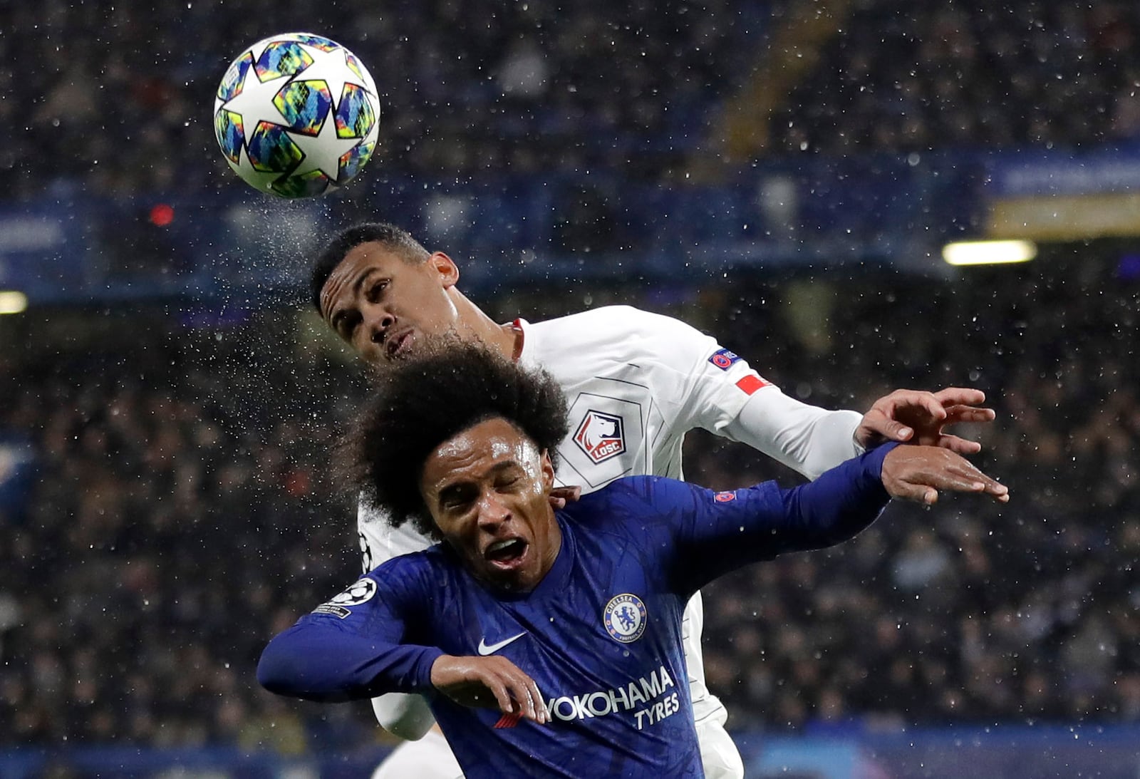 FILE - In this Tuesday, Dec. 10, 2019 file photo, Chelsea's Willian fights for the ball against Lille's Gabriel, rear, during the Champions League Group H soccer match between Chelsea and Lille at Stamford Bridge stadium in London Premier League clubs have been busy in the transfer market in an unusually short offseason because of pandemic-induced late finish to last season. Among the other intriguing transfers is Brazilian center back Gabriel to Arsenal. (AP Photo/Kirsty Wigglesworth, File)