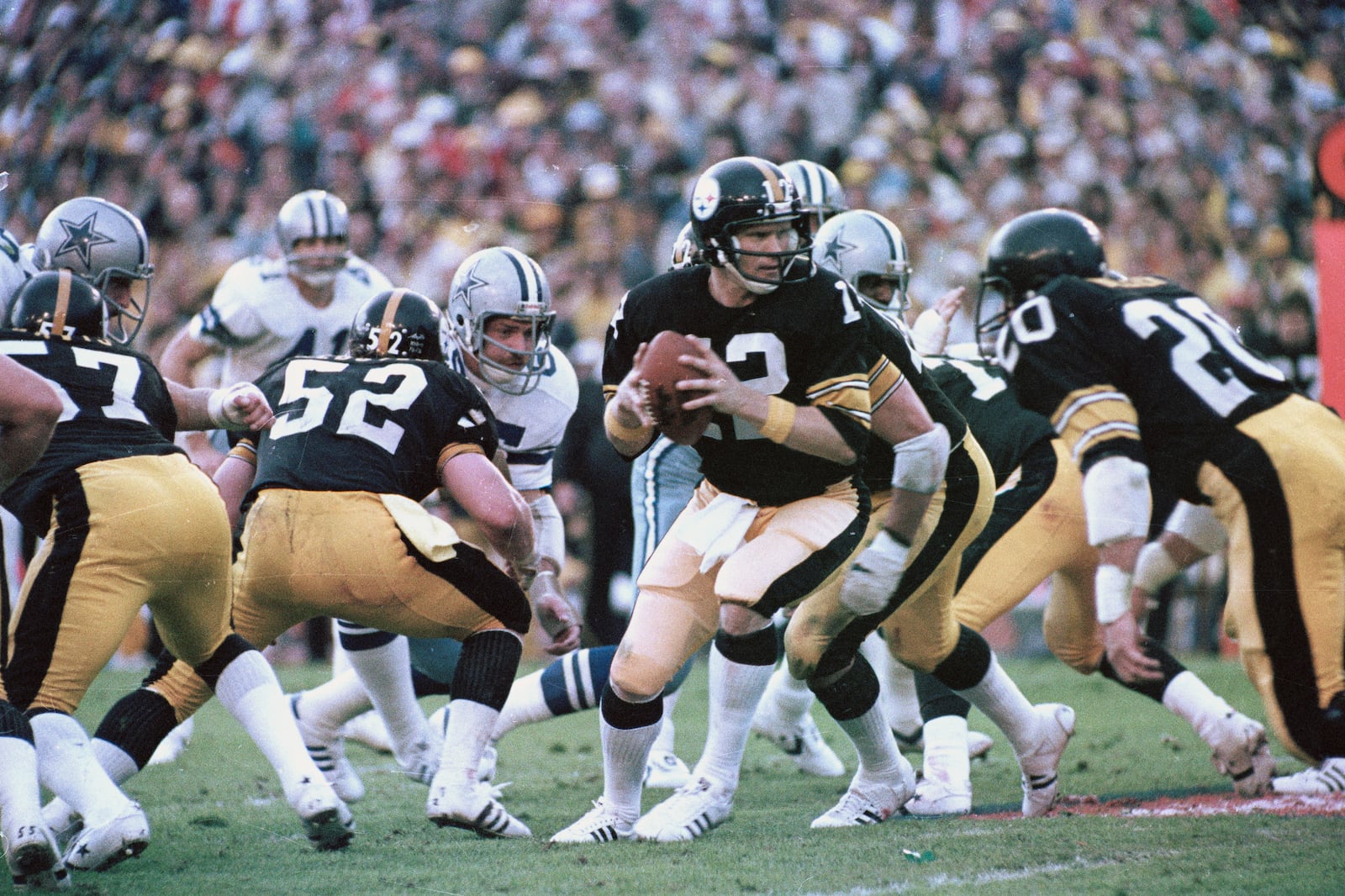 FILE - Pittsburgh Steelers quarterback Terry Bradshaw (12) turns around with the ball after the snap to hand the ball to an open receiver against the Dallas Cowboys in Super Bowl XIII action in Miami, Fla., Jan. 21, 1979. Steelers running back Rocky Blier (20) is at right. (AP Photo/File)