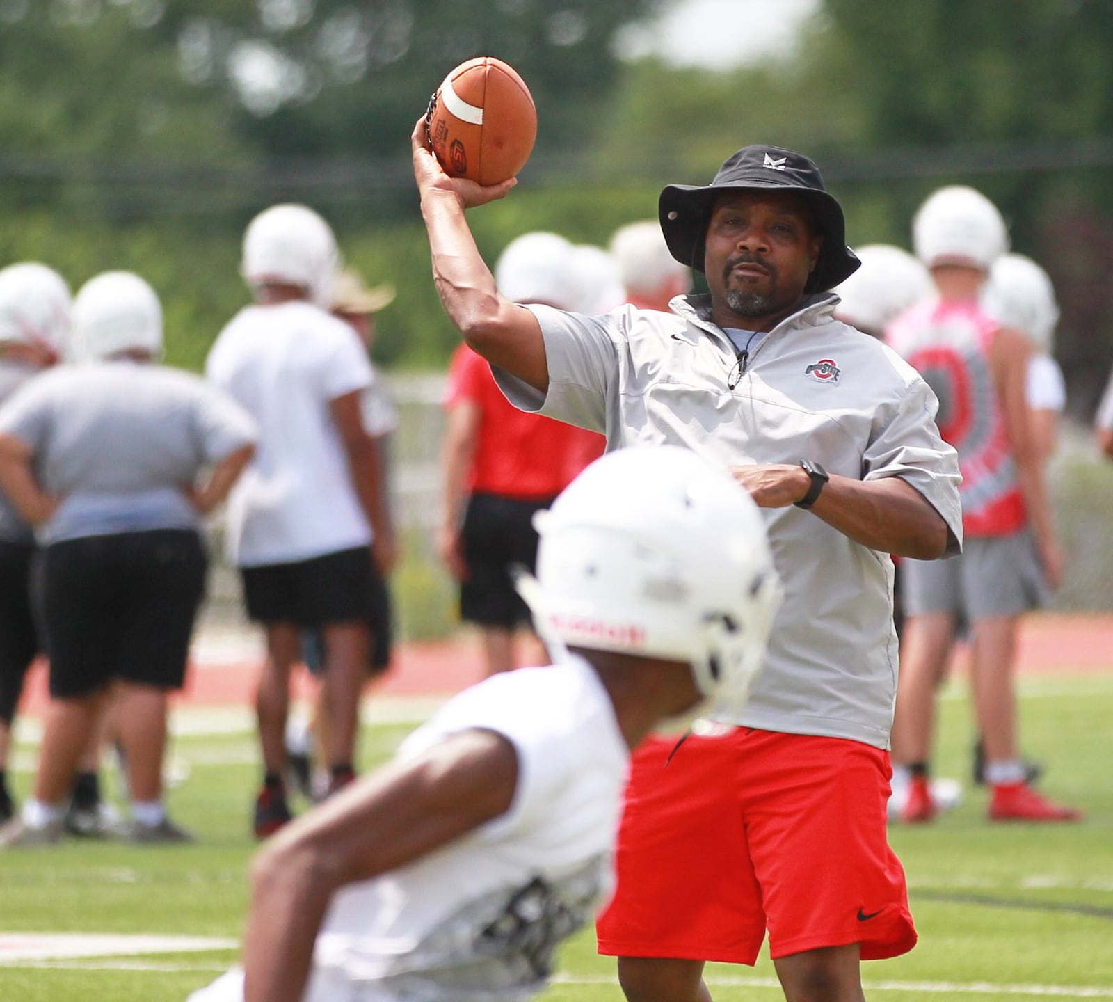 Roosevelt Mukes (passing) is in his first season as the Wayne High School head football coach. The Warriors held their first preseason football practice on Thursday, Aug. 1, 2019. MARC PENDLETON / STAFF