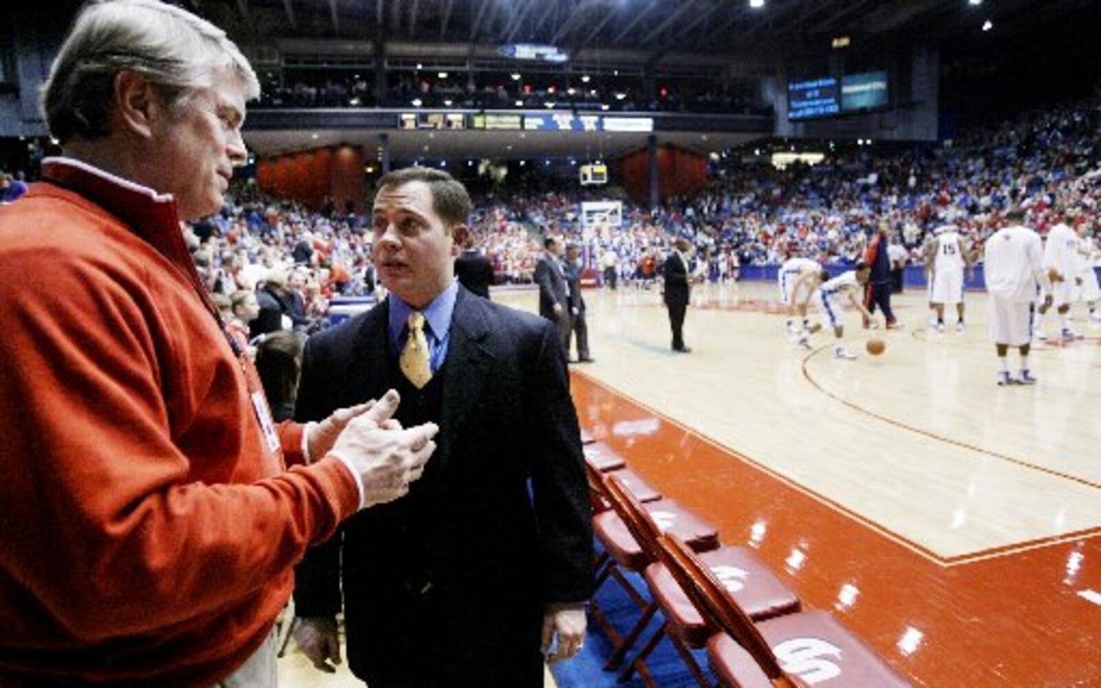 Orthopedic Consultant for the University of Dayton Athletics Dr. Tim Quinn talks with Associate Head Athletic Trainer Nate Seymour during the Flyers basketball game against Duquesne. Staff Photo by Teesha McClam