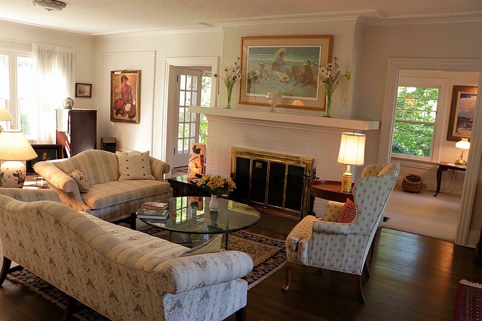 A wood-burning fireplace can be enjoyed from the formal living room and the adjoining sun room, which was set up as an office. CONTRIBUTED PHOTO BY KATHY TYLER