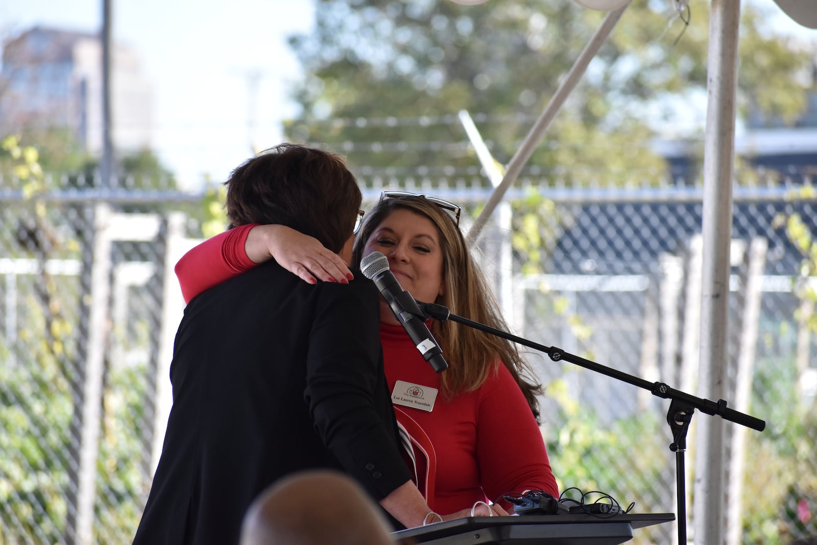 Lee Alder Truesdale, chief development officer of the Dayton Foodbank Inc., hugs Michelle Riley, CEO of the Foodbank, during a recent groundbreaking ceremony for the Foodbank's new community building. SAM WILDOW\STAFF