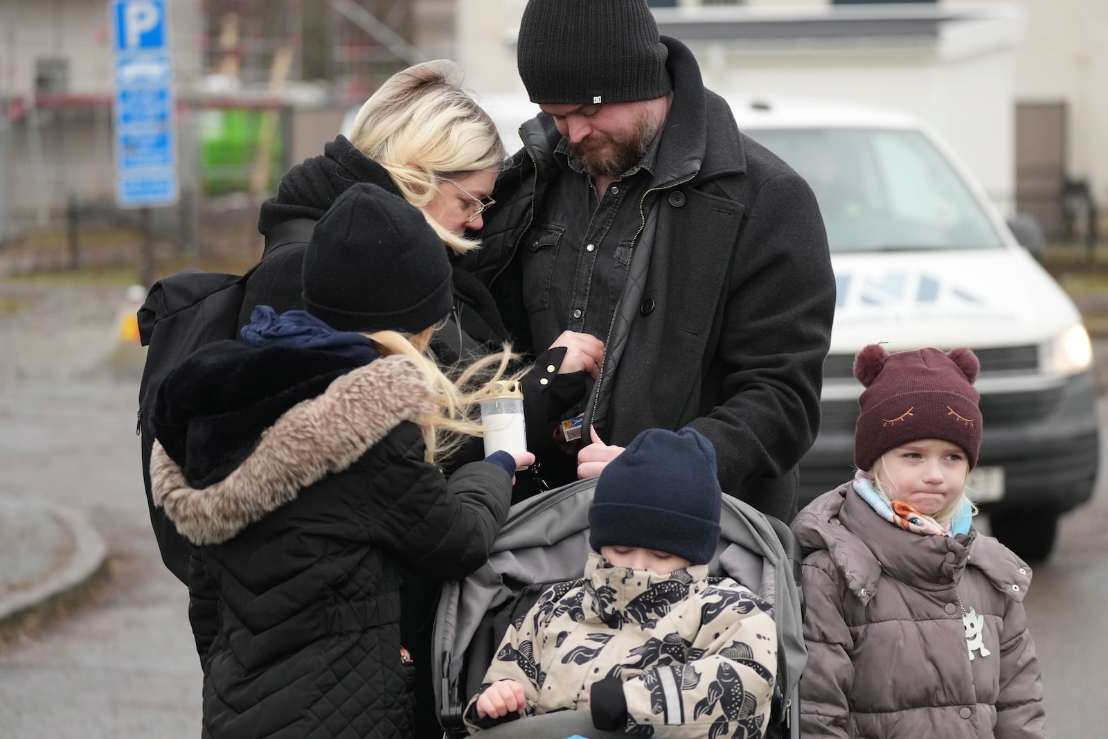 People light candles at a makeshift memorial near the scene of a shooting on the outskirts of Orebro, Sweden, Wednesday, Feb. 5, 2025. (AP Photo/Sergei Grits)