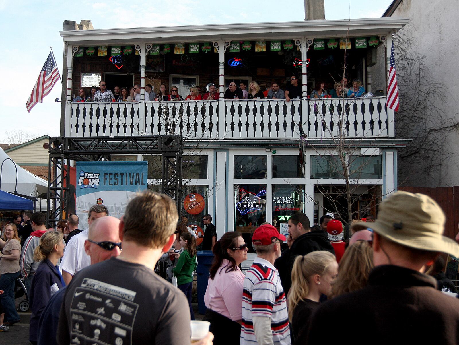 E.L. Hubbard photography People fill the street and a balcony during the NCAA First Four Festival in downtown Dayton's Oregon District Sunday, March 11, 2012.