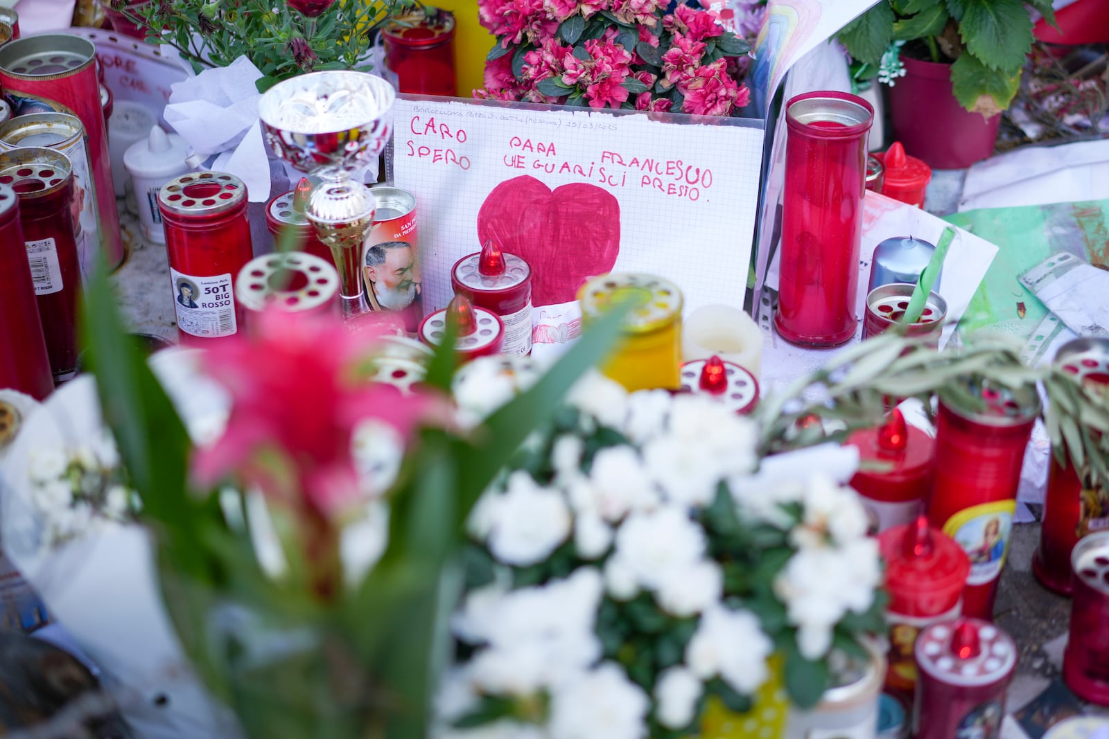 People pray for Pope Francis in front of the Agostino Gemelli Polyclinic, in Rome, Tuesday, March 18, 2025, where the Pontiff is hospitalized since Feb. 14. (AP Photo/Andrew Medichini)