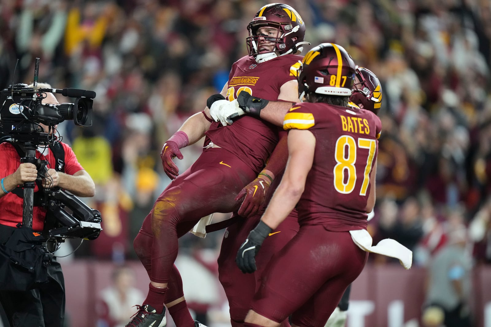 Washington Commanders tight end Zach Ertz celebrates his game winning touchdown in overtime during an NFL football game against the Atlanta Falcons, Sunday, Dec. 29, 2024, in Landover, Md. The Commanders won 30-24. (AP Photo/Stephanie Scarbrough)