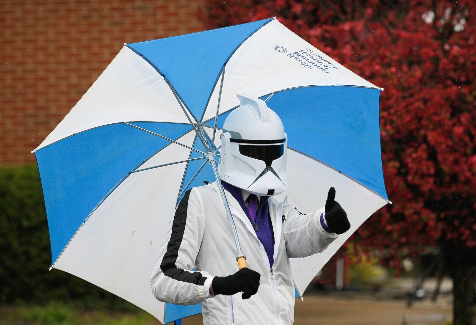 Bryson Jackson dons a Star Wars storm trooper mask while welcoming people to First Grace Church’s drive-in service. During the coronavirus pandemic, members of the Butler Twp. church have met in the parking lot but stayed in their cars. CHRIS STEWART / STAFF