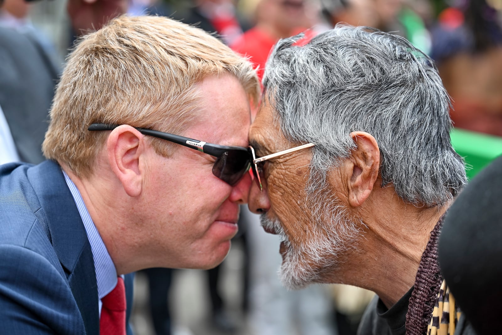 New Zealand's opposition leader Chris Hipkins, left, does a hongi with Hare Arapere as people gathered outside New Zealand's parliament to protest a proposed law that would redefine the country's founding agreement between Indigenous Māori and the British Crown, in Wellington Tuesday, Nov. 19, 2024. (AP Photo/Mark Tantrum)