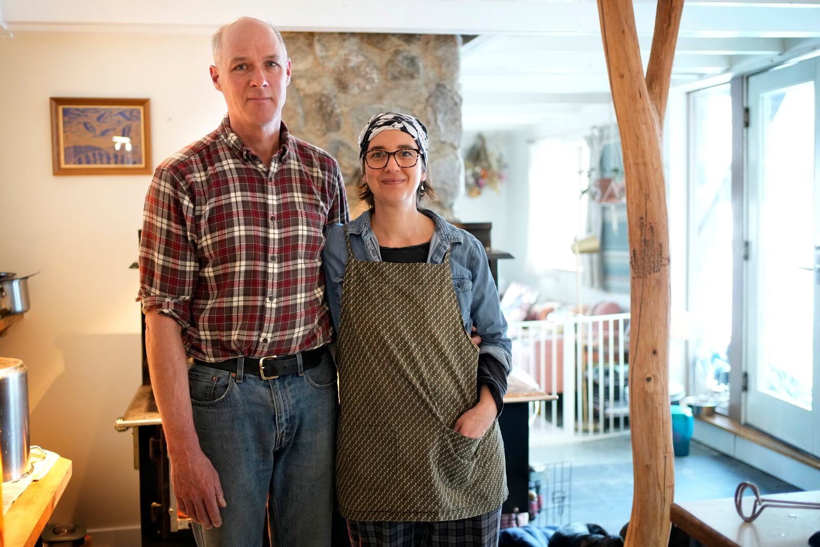 Organic wild blueberry farmers Hugh and Jenny Lassen pose in their home, Monday, Feb. 10, 2025, in Cherryfield, Maine. (AP Photo/Robert F. Bukaty)