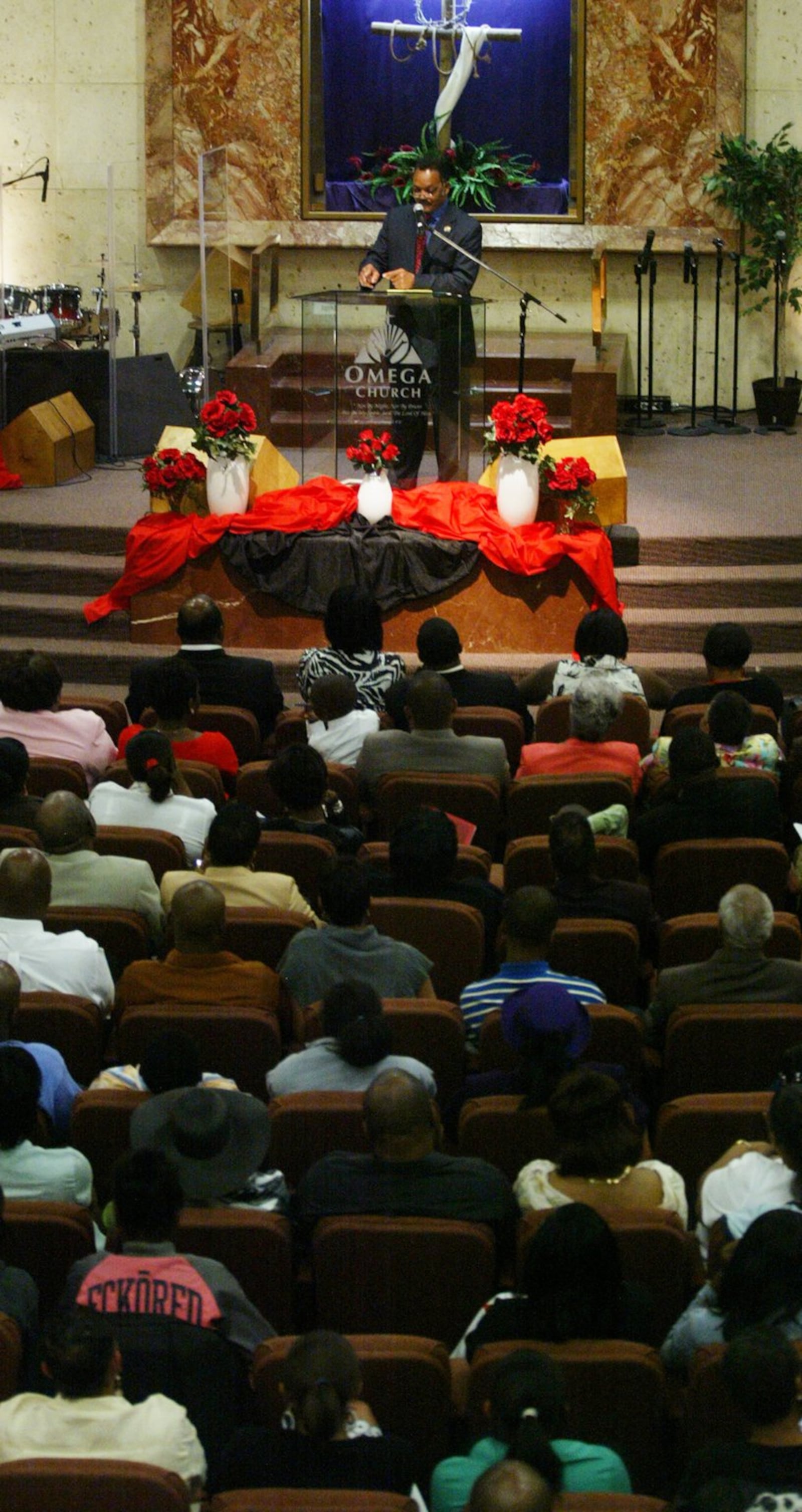 Rev. Jesse Jackson gives a sermon to the community of Omega Baptist Church Sunday. Staff Photo by Teesha McClam