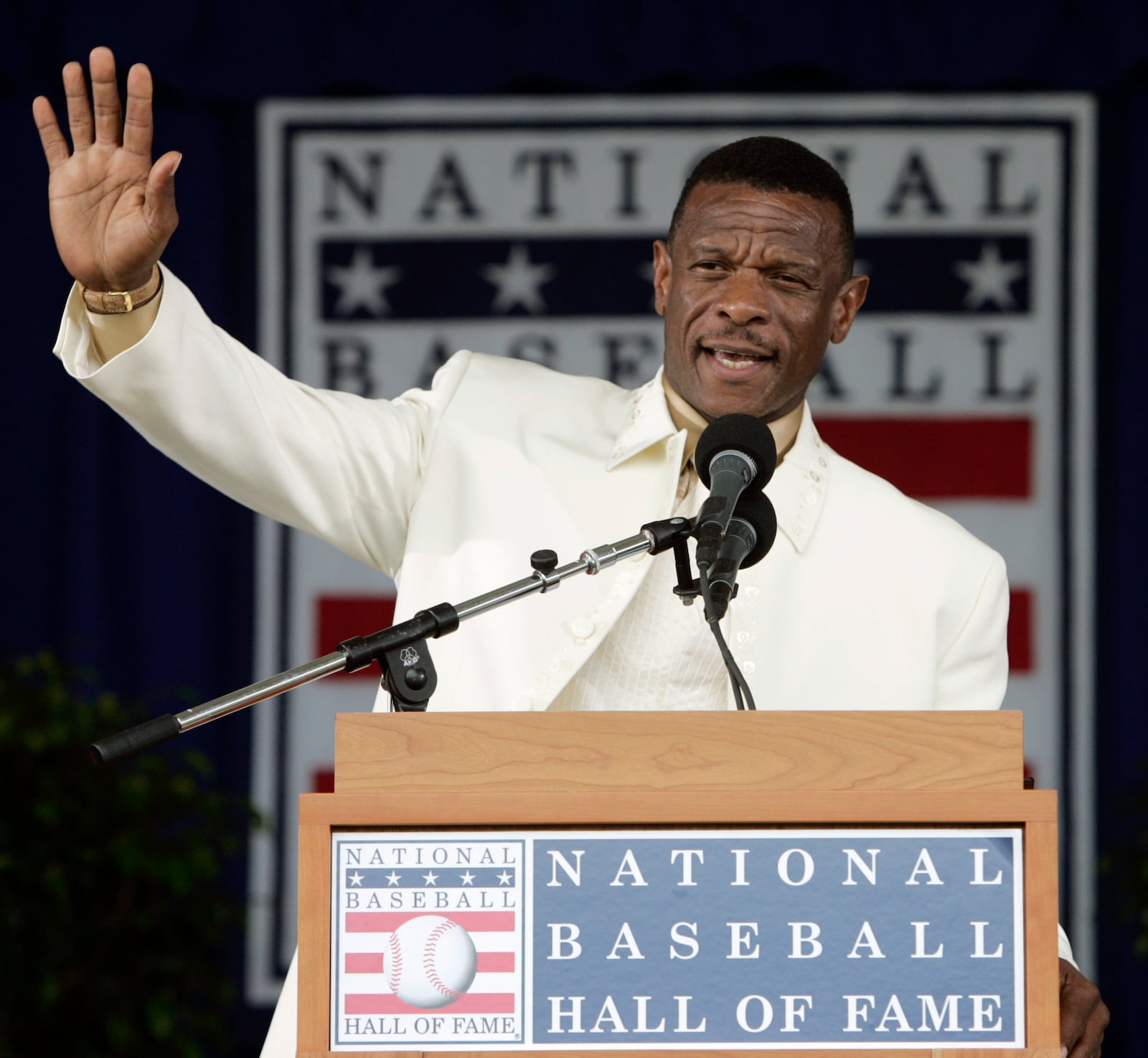 FILE - Rickey Henderson waves to the crowd during his induction speech at the Baseball Hall of Fame in Cooperstown, N.Y., July 26, 2009. (AP Photo/Mike Groll, File)