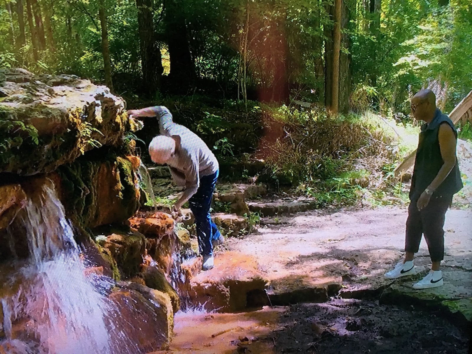 David Letterman drinks from the Yellow Springs in Glen Helen as Dave Chappelle watches during Letterman's Netflix special "My Next Guess Needs No Introduction."