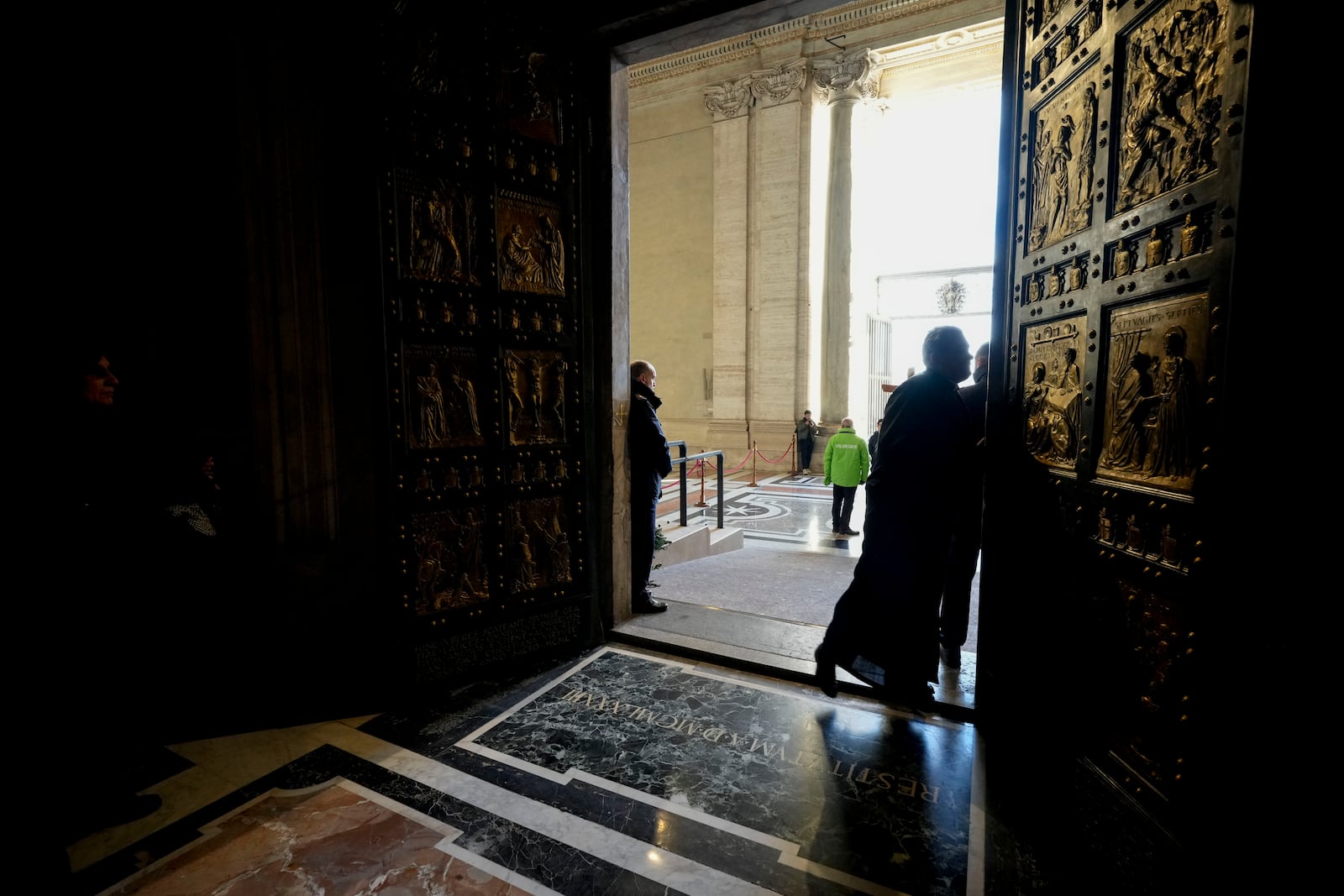 Faithful walk through the Holy Door of St. Peter's Basilica at the Vatican, Wednesday, Dec. 25, 2024, after it was opened by Pope Francis on Christmas Eve marking the start of the Catholic 2025 Jubilee. (AP Photo/Andrew Medichini)