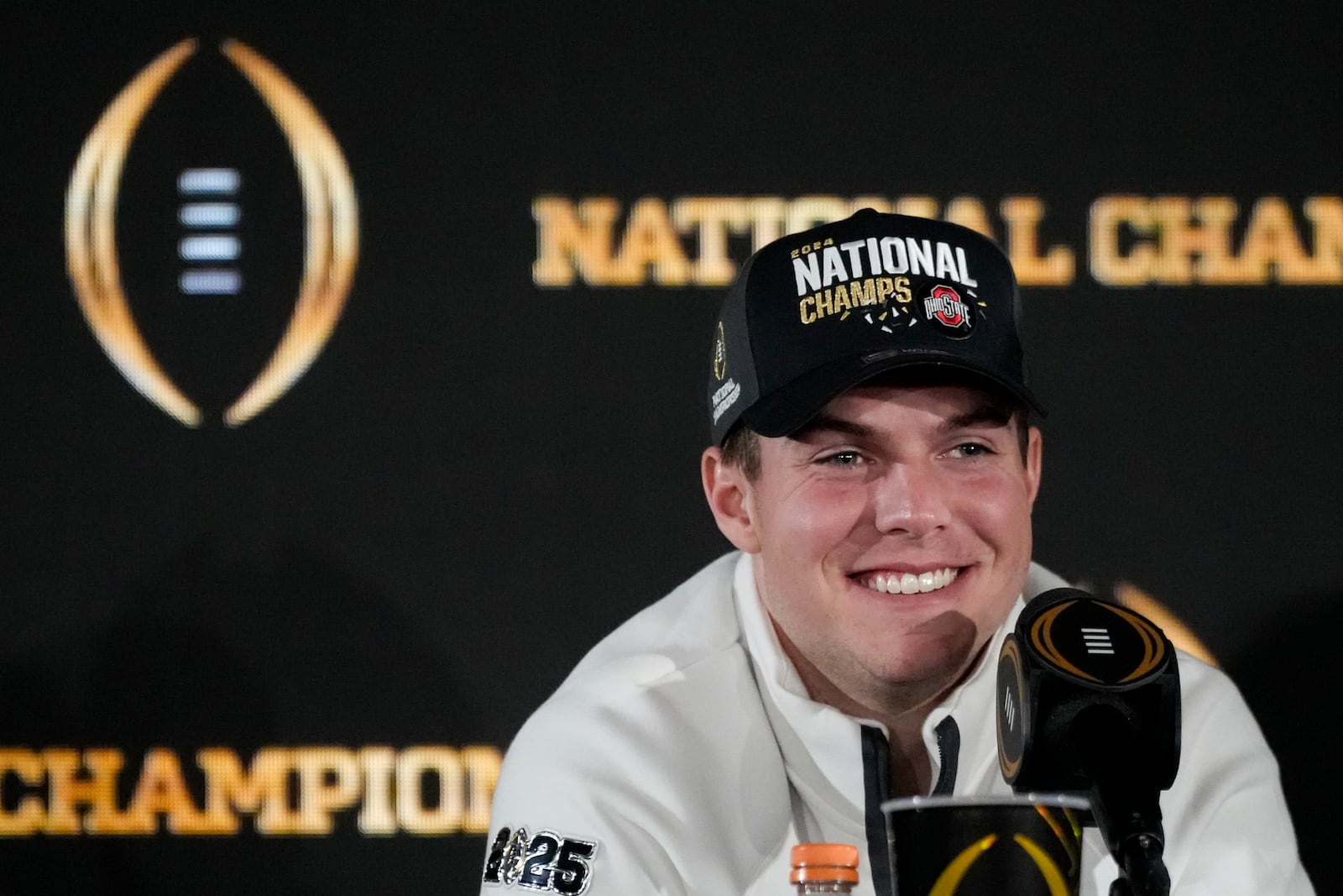 Ohio State quarterback Will Howard smiles during the winners news conference after the College Football Playoff national championship game against Notre Dame Tuesday, Jan. 21, 2025, in Atlanta. (AP Photo/Chris Carlson)