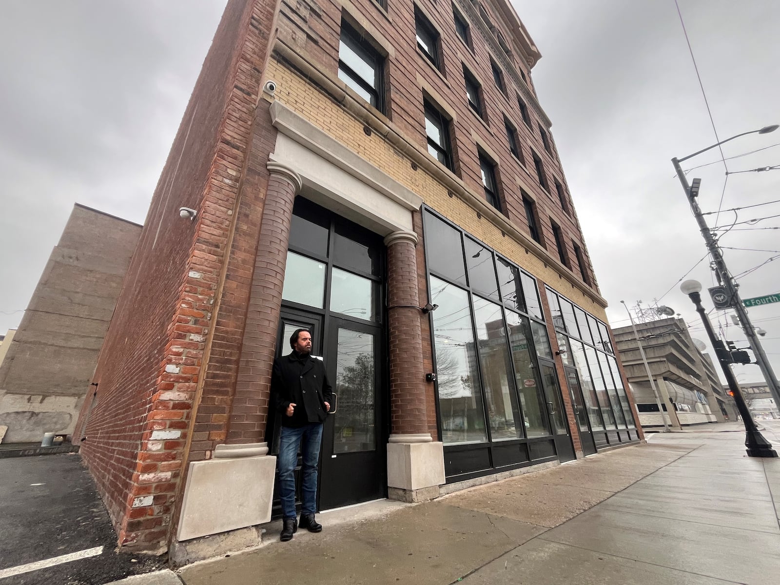 Jason Dorsey, asset director for Windsor Companies, stands at the entrance of the Home Telephone Lofts, located on South Jefferson Street in downtown Dayton. Windsor Companies has transformed the building, which was most recently Price Stores, a men's clothing business. CORNELIUS FROLIK / STAFF