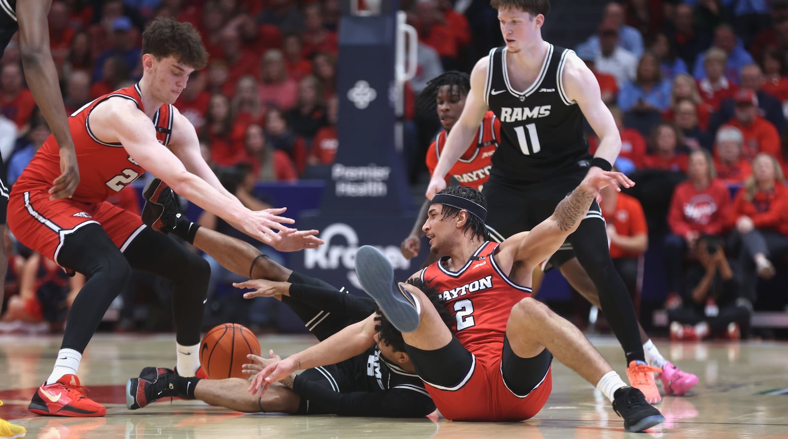 Dayton and Virginia Commonwealth compete for a loose ball in the first half on Friday, Feb. 7, 2025, at UD Arena.. David Jablonski/Staff