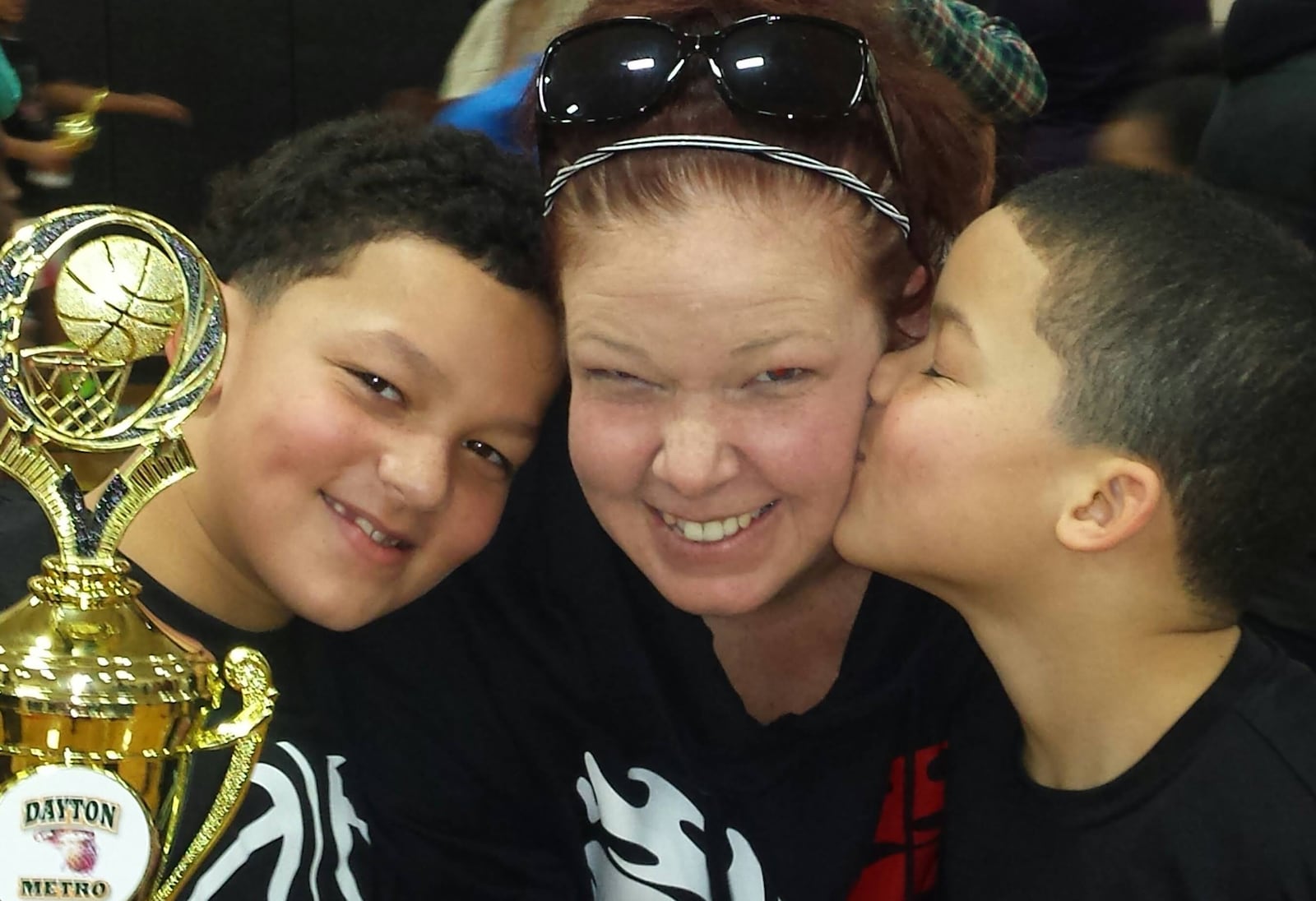 Kim Nelson gets some real love from her twin sons, Issiah (left) and Garfield, doing the smooching. (Contributed photo)