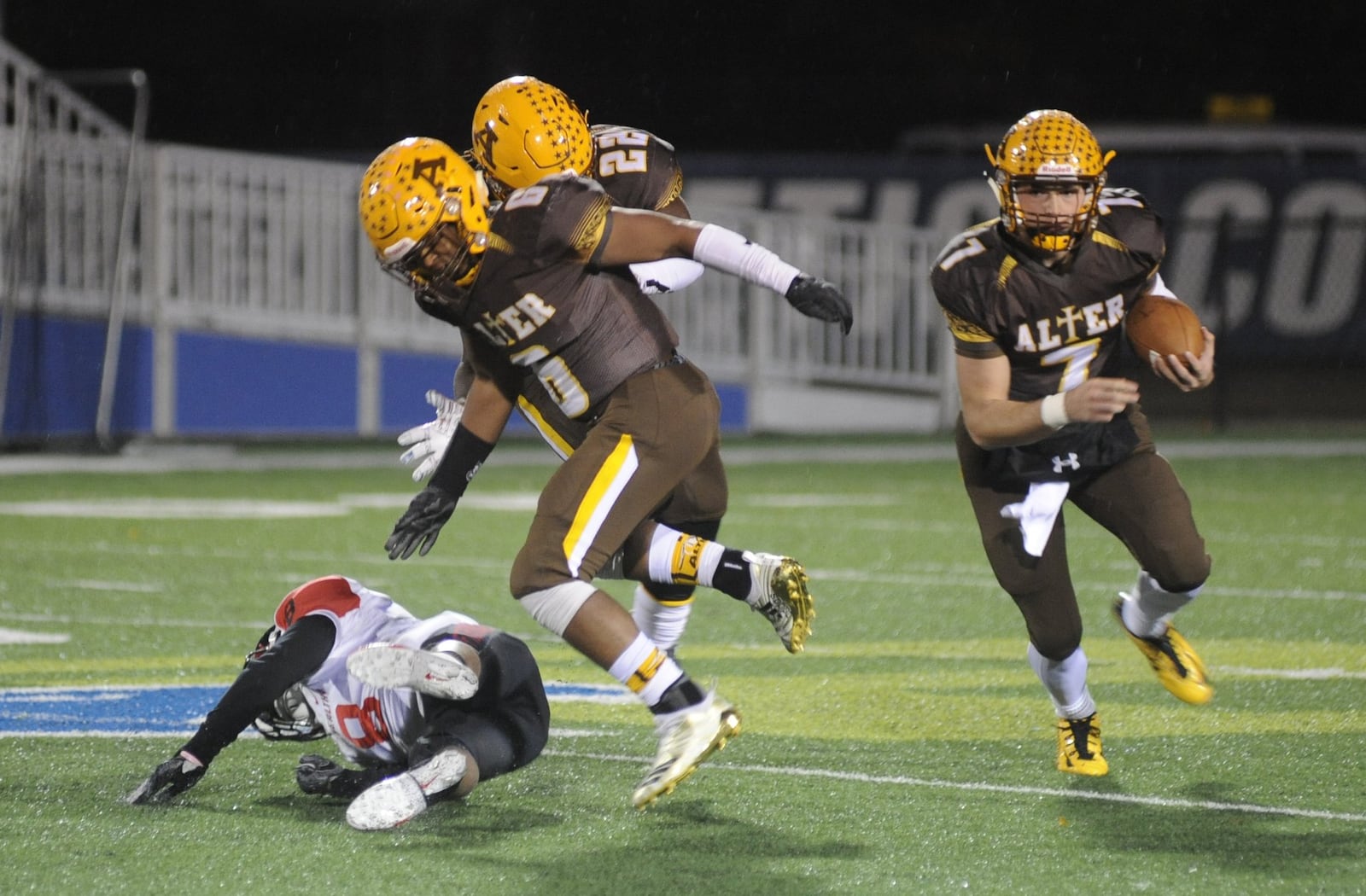 Alter’s Lamar Landers (6) and Branden McDonald (22) clear the way for Knights QB Connor Bazelak. Alter defeated Cin. Mt. Healthy 14-12 in a D-III, Region 12 quarterfinal high school football playoff game at Fairmont’s Roush Stadium on Friday, Nov. 2, 201. MARC PENDLETON / STAFF