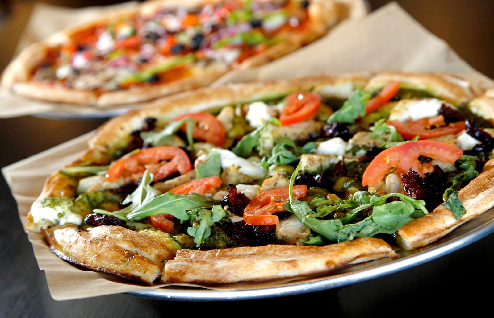 Ray Wiley and his business partners have recently opened Rapid Fired Pizza in Washington Twp. Customers order custom made pizza in a serving line similar to Chipotle in the new "fast-casual" chain.  LISA POWELL / STAFF