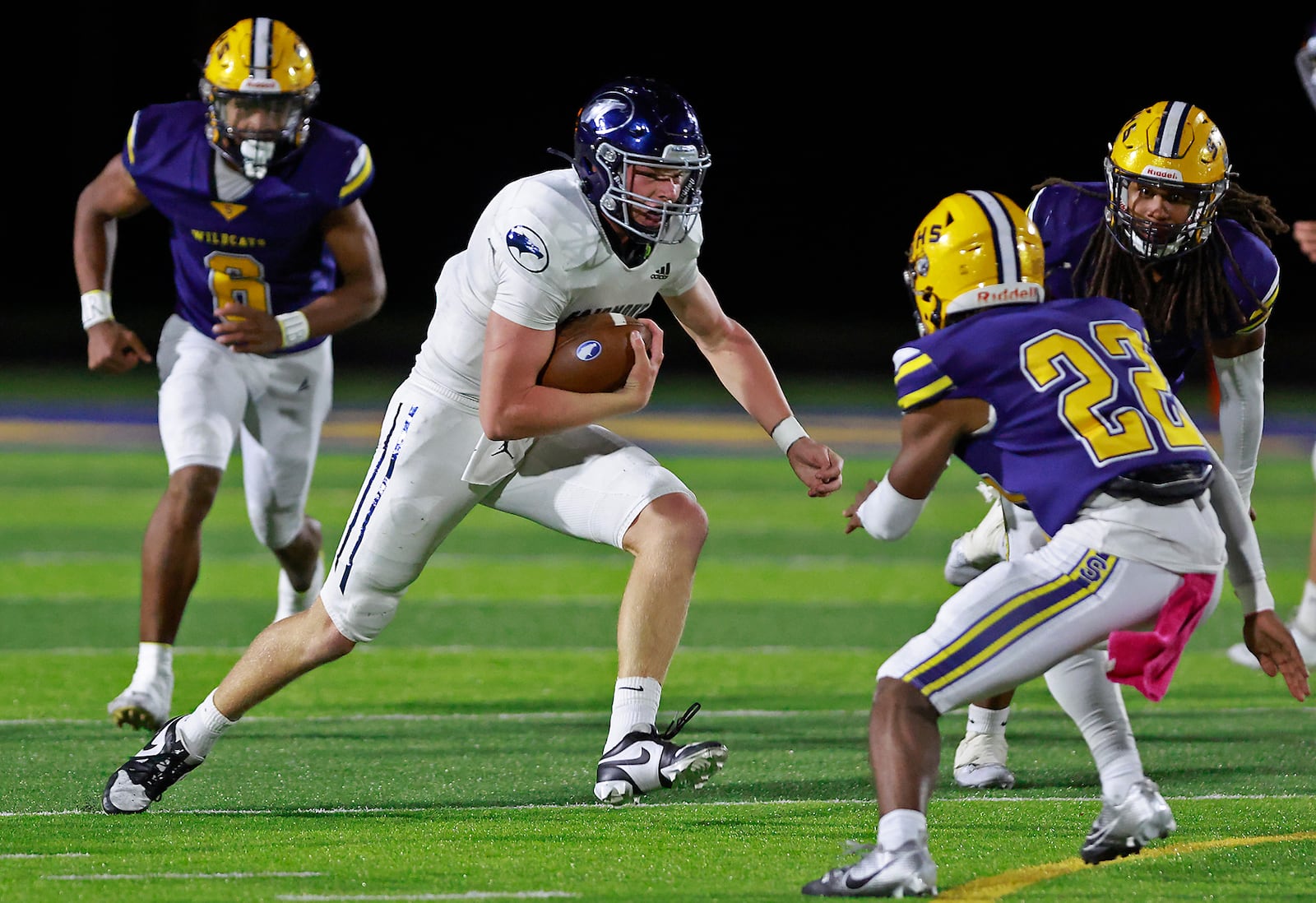 Fairmont quarterback Brock Baker tries to avoid a tackle by Springfield's Tre Montgomery as he carries the ball. BILL LACKEY/STAFF