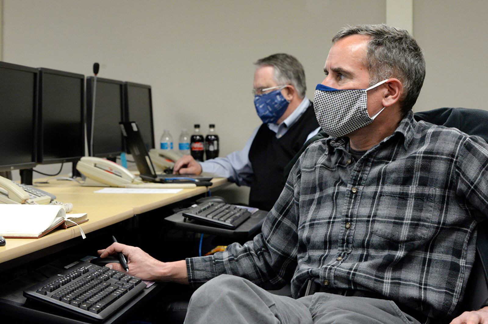 To help maintain safety around the installation, William Neitzke (right), director of safety for the 88th Air Base Wing, listens to a conference call while monitoring the COVID-19 pandemic at Wright-Patterson Air Force Base May 5, 2020. U.S. AIR FORCE PHOTO/TY GREENLEES