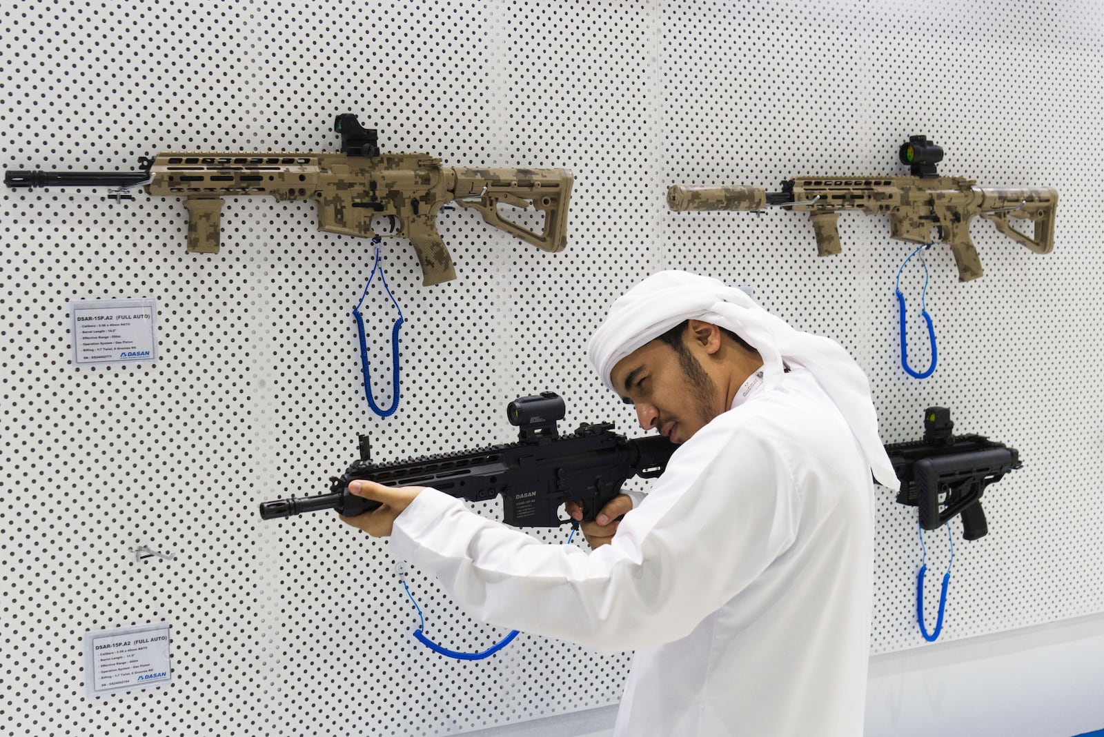 An Emirati man aims with a South Korean-made DSAR-15 rifle at the biennial International Defense Exhibition and Conference arms show in Abu Dhabi, United Arab Emirates, Monday, Feb. 17, 2025. (AP Photo/Jon Gambrell)