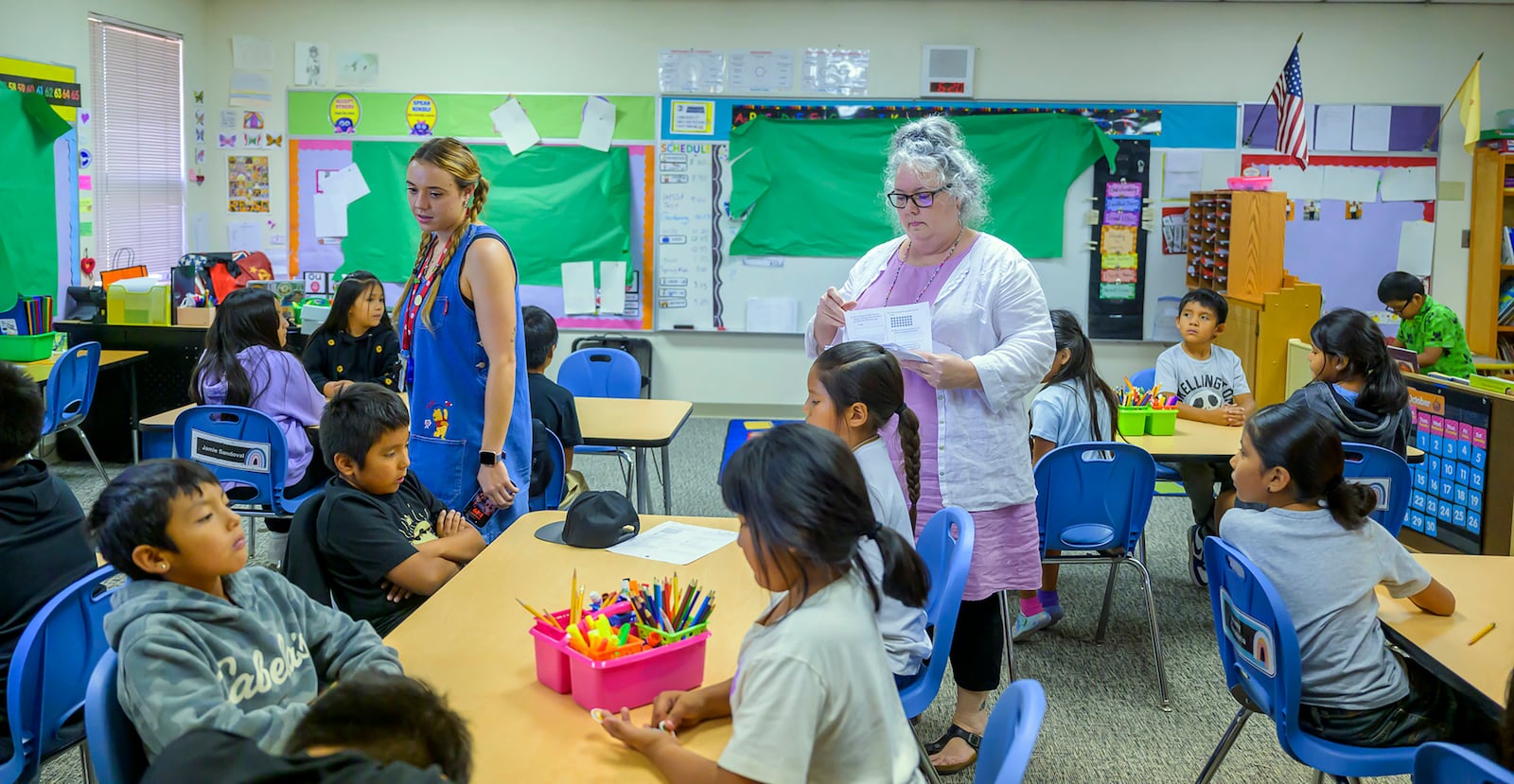 Third grade teachers Ciara Key, left, and Arden Serrato handing out tests, Tuesday, Oct. 1, 2024, at Algodones Elementary School in Algodones, N.M. (AP Photo/Roberto E. Rosales)