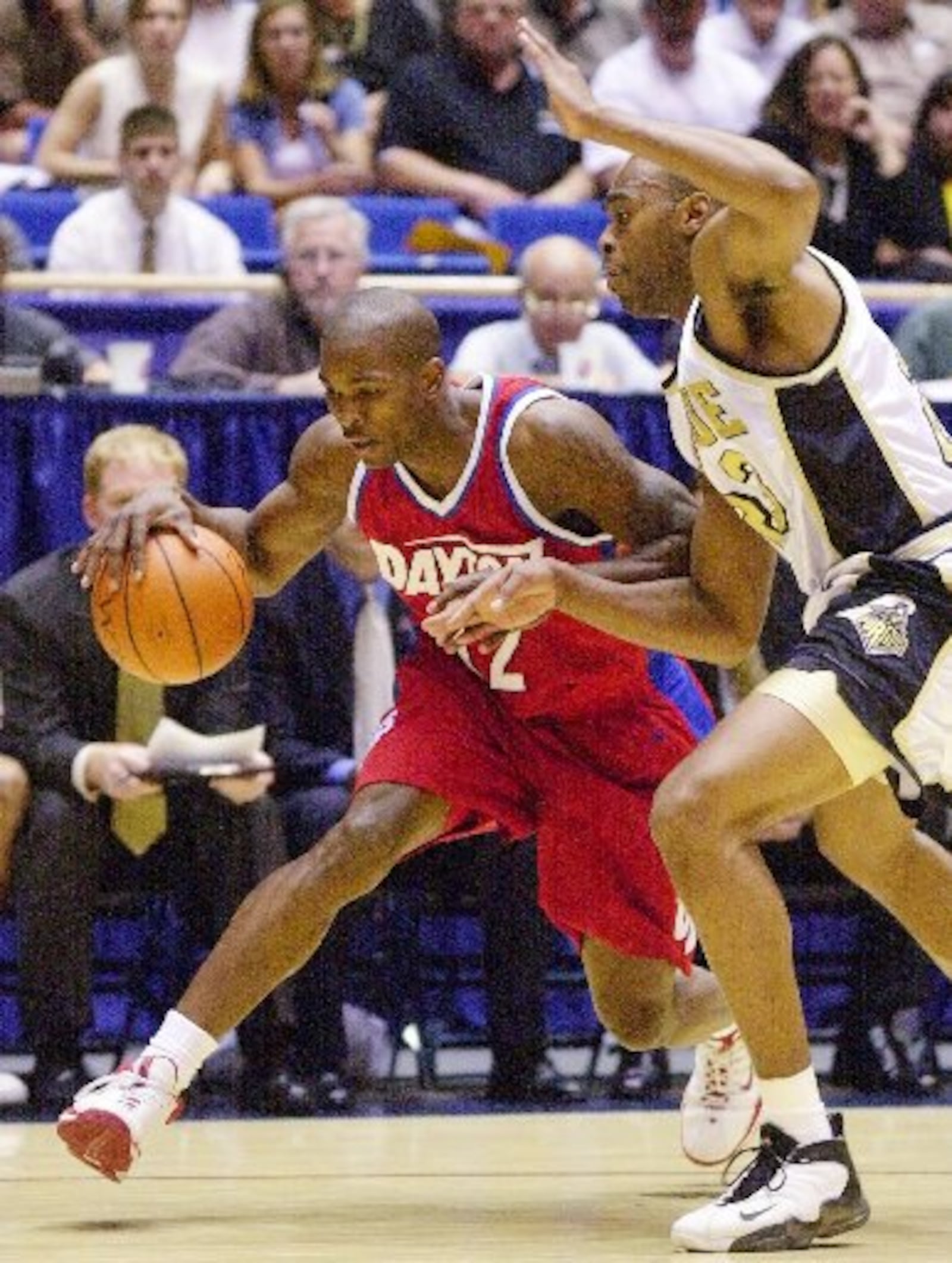 Purdue forward Mike Robinson, right, applies the defensive pressure on Dayton guard Tony Stanley during the second half in the NCAA West Regional in Tucson, Ariz, on Thursday, March 16, 2000. Purdue beat Dayton 62-61. (AP Photo/Matt York)