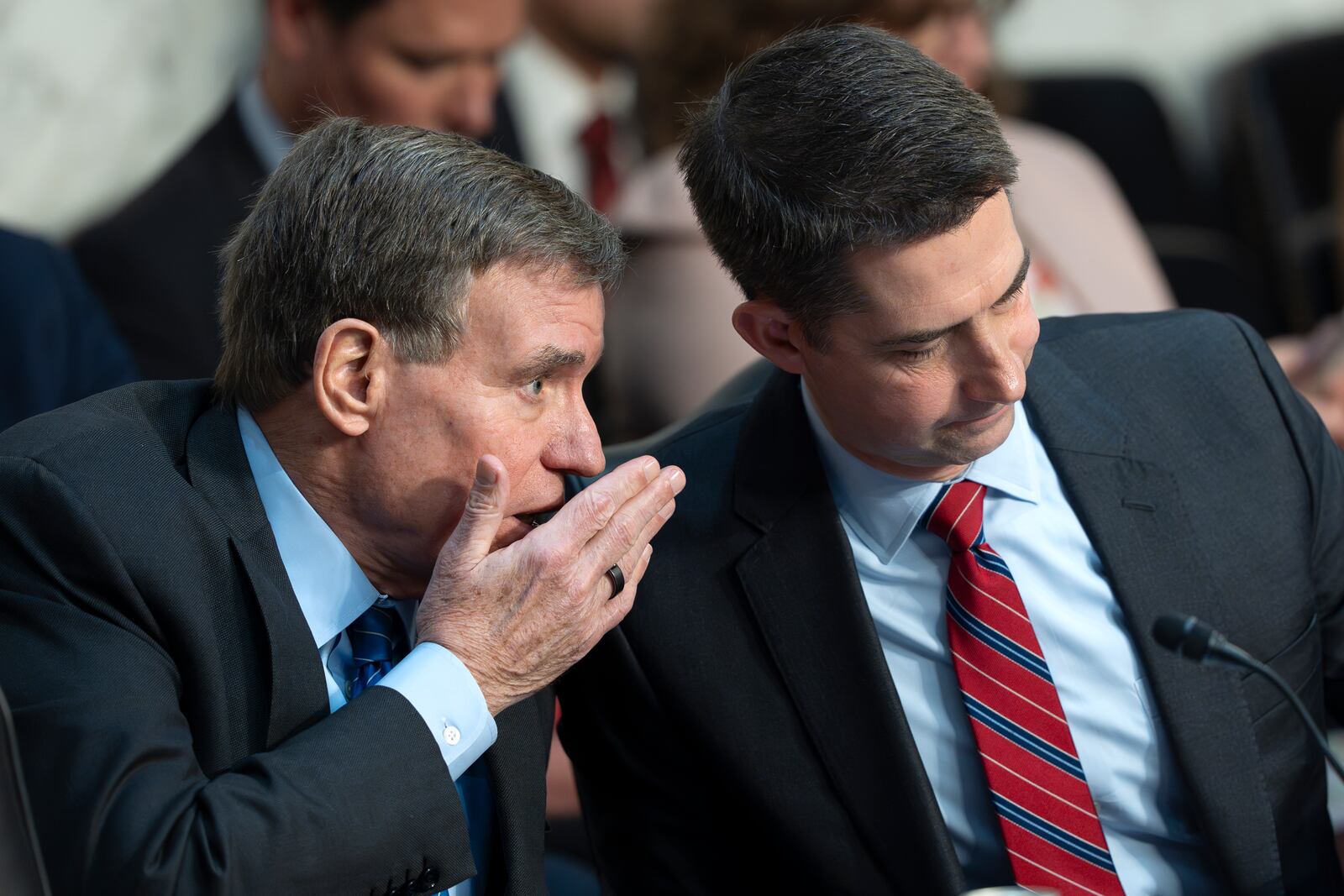 Sen. Mark Warner, D-Va., vice chair of the Senate Intelligence Committee, left, confers with Chairman Tom Cotton, R-Ark., during a hearing on worldwide threats, on Capitol Hill in Washington, Tuesday, March 25, 2025. (AP Photo/J. Scott Applewhite)