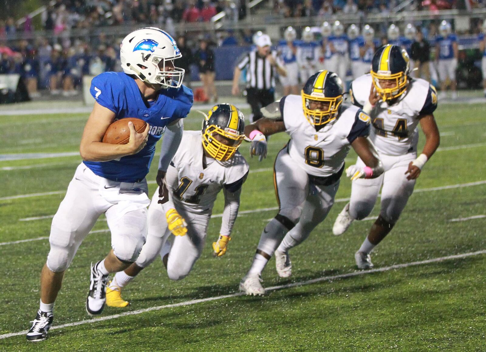 Springboro QB Landon Palmer is chased by Springfield defenders Xzerious Stinnett (11), Bryce Walker (9) and Tayden Harper (44). Springfield defeated host Springboro 23-0 in a Week 7 high school football game on Friday, Oct. 11, 2019. MARC PENDLETON / STAFF