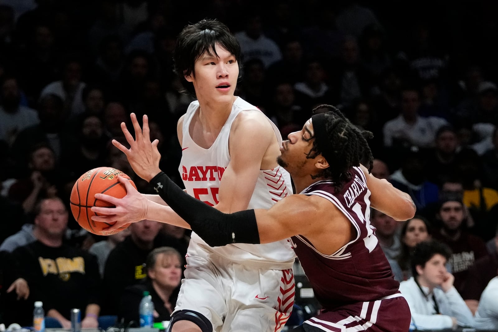 Fordham's Antrell Charlton (24) defends Dayton's Mike Sharavjamts (55), of Mongolia, during the first half of an NCAA college basketball game in the semifinals of the Atlantic 10 Conference Tournament, Saturday, March 11, 2023, in New York. (AP Photo/Frank Franklin II)