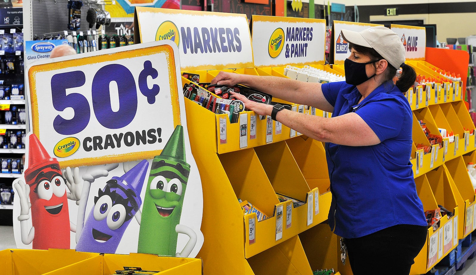 Connie Michell, a manager at the Meijer Store on Wilmington Pike, straightens the school supplies on Friday. MARSHALL GORBY\STAFF