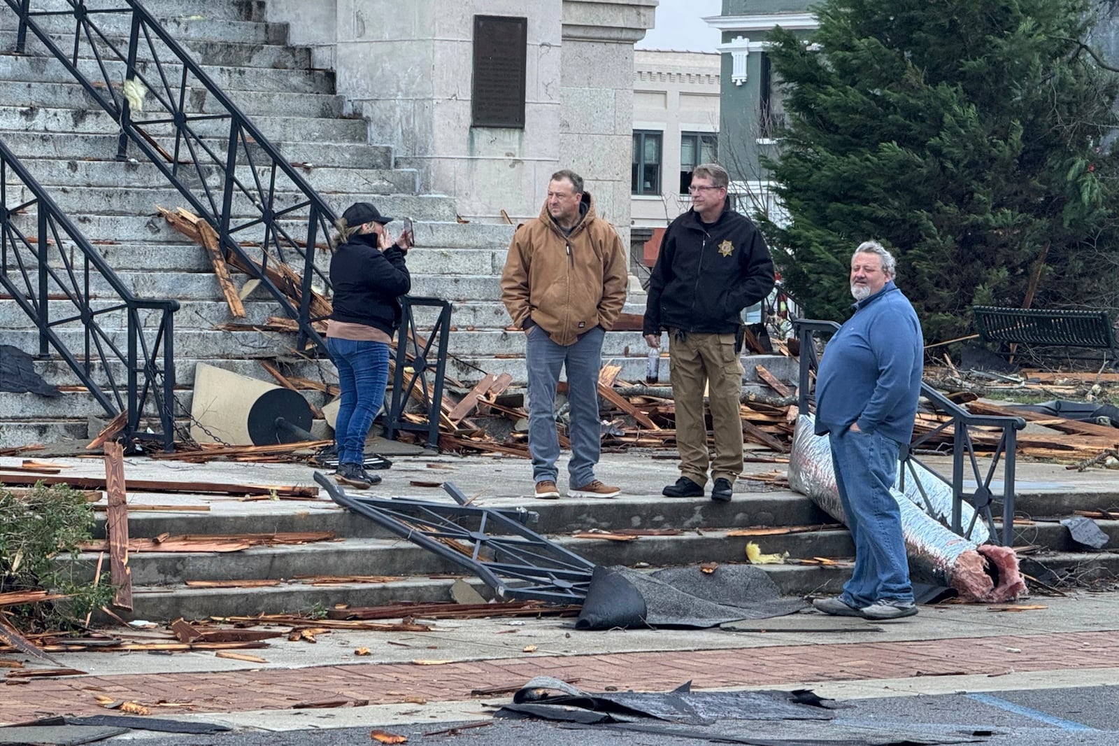 People view damage from a storm through that rolled through the night before is seen at the heart of downtown on Sunday, Dec. 29, 2024, in Athens, Ala. (AP Photo/Lance George)