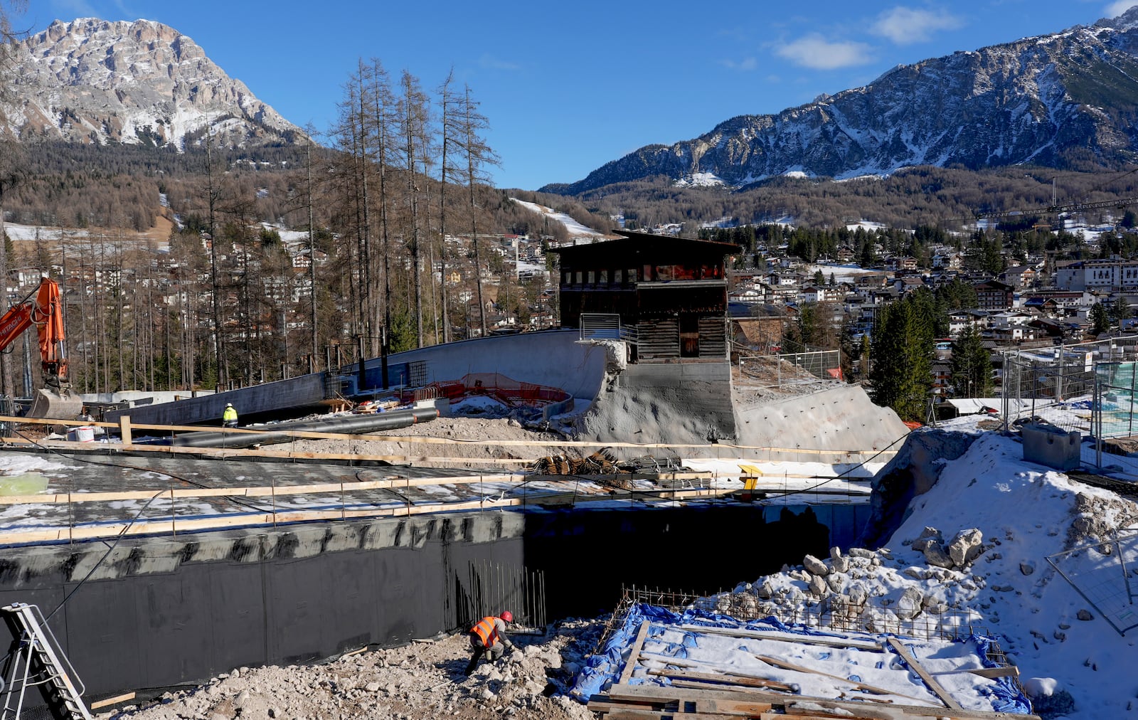 Construction work takes place at the Cortina Sliding Center, venue for the bob, luge and skeleton disciplines, at the Milan Cortina 2026 Winter Olympics, in Cortina d'Ampezzo, Italy, Thursday, Jan. 16, 2025. (AP Photo/Giovanni Auletta)