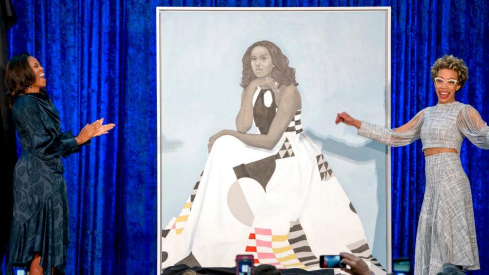 Former first lady Michelle Obama and Artist Amy Sherald, right, unveil Michelle Obama's official portrait at the Smithsonian's National Portrait Gallery, Monday, Feb. 12, 2018, in Washington. (AP Photo/Andrew Harnik)