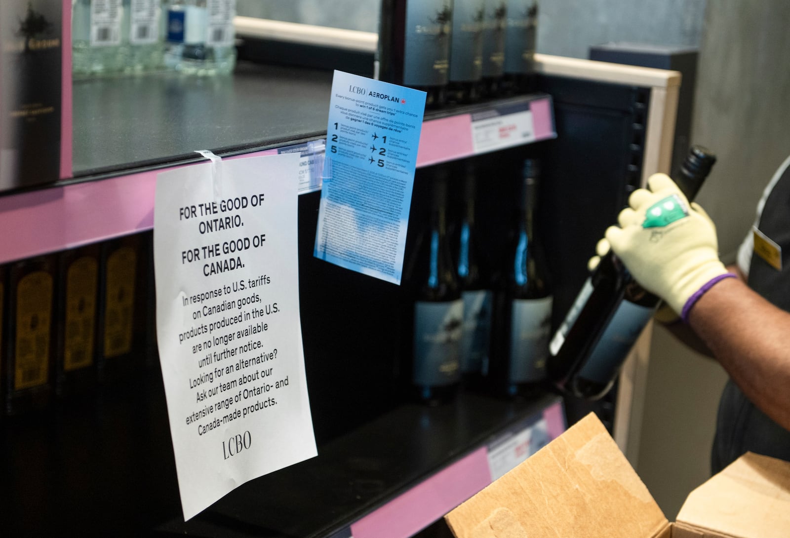 A sign announcing the removal of American-made products hangs from a shelf at the 100 Queens Quay East LCBO outlet in Toronto on Tuesday, March 4, 2025. (Laura Proctor /The Canadian Press via AP)