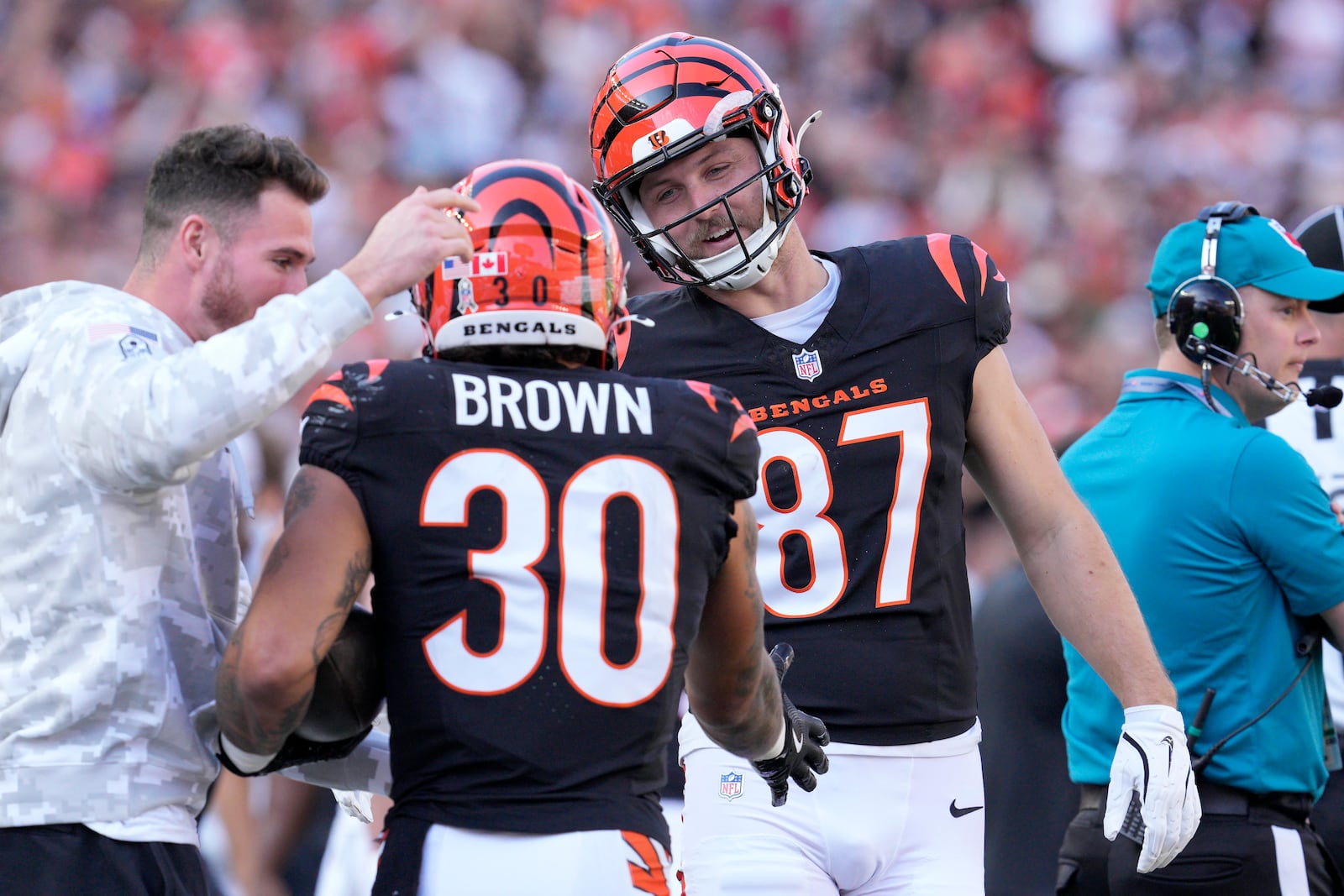 Cincinnati Bengals running back Chase Brown (30) is congratulated by tight end Tanner Hudson (87) after scoring during the first half of an NFL football game against the Las Vegas Raiders in Cincinnati, Sunday, Nov. 3, 2024. (AP Photo/Jeff Dean)