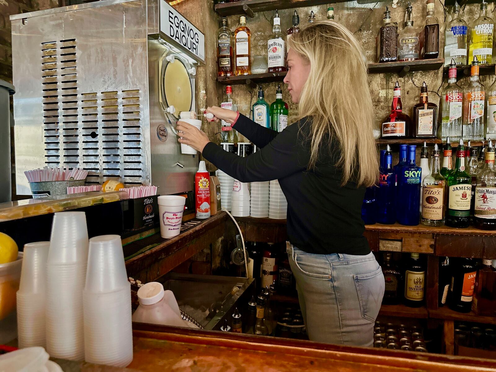 Jamie Gourgues, marketing manager of Lafitte's Blacksmith Shop, prepares an eggnog daiquiri in New Orleans on Thursday, Dec. 12, 2024. (AP Photo/Stephen Smith)