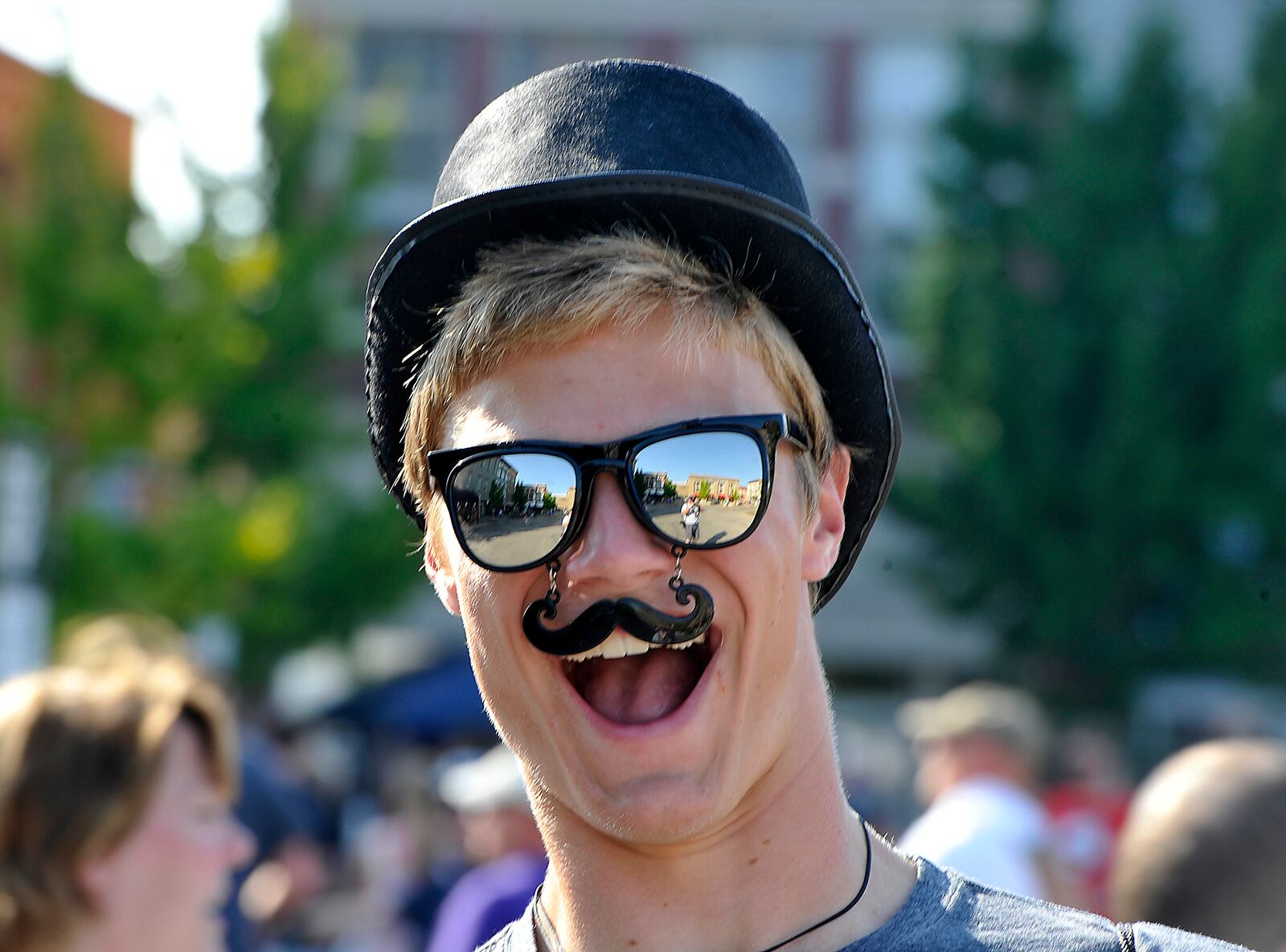 A fan with his Mumford and Sons mustache and hat Friday in Troy. Bill Lackey/Staff