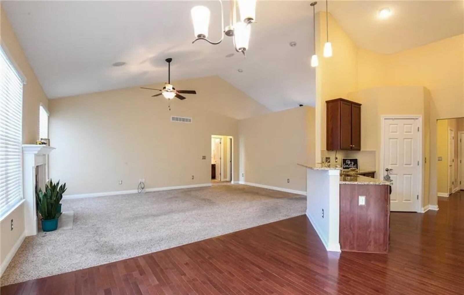 A cathedral ceiling starts at the foyer and peaks above the great room, which has a gas fireplace flanked by two windows. CONTRIBUTED