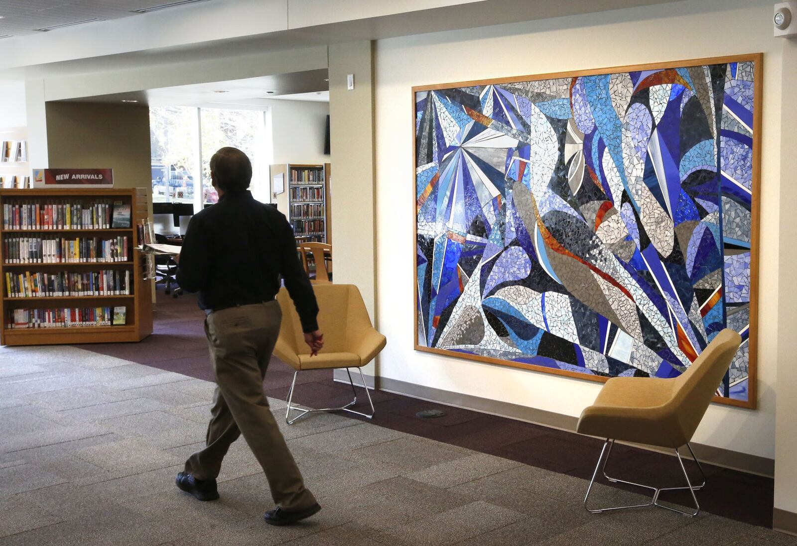 The new Kettering-Moraine branch of the Dayton Metro Library is due to open on Tuesday, October 18. Building architect Gary Spangler walks past artwork by Gail Christofferson who took inspiration from Christopher Ries work “Clelbration”. TY GREENLEES / STAFF