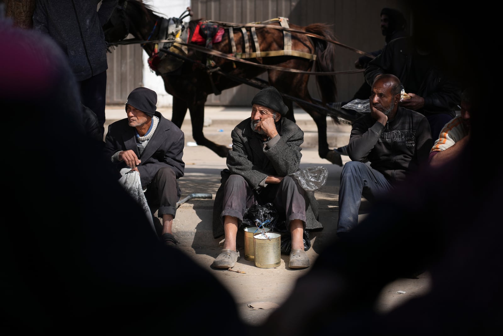 Palestinians queue for food distribution in Deir al-Balah, Gaza Strip, Friday, Feb. 14, 2025. (AP Photo/Abdel Kareem Hana)